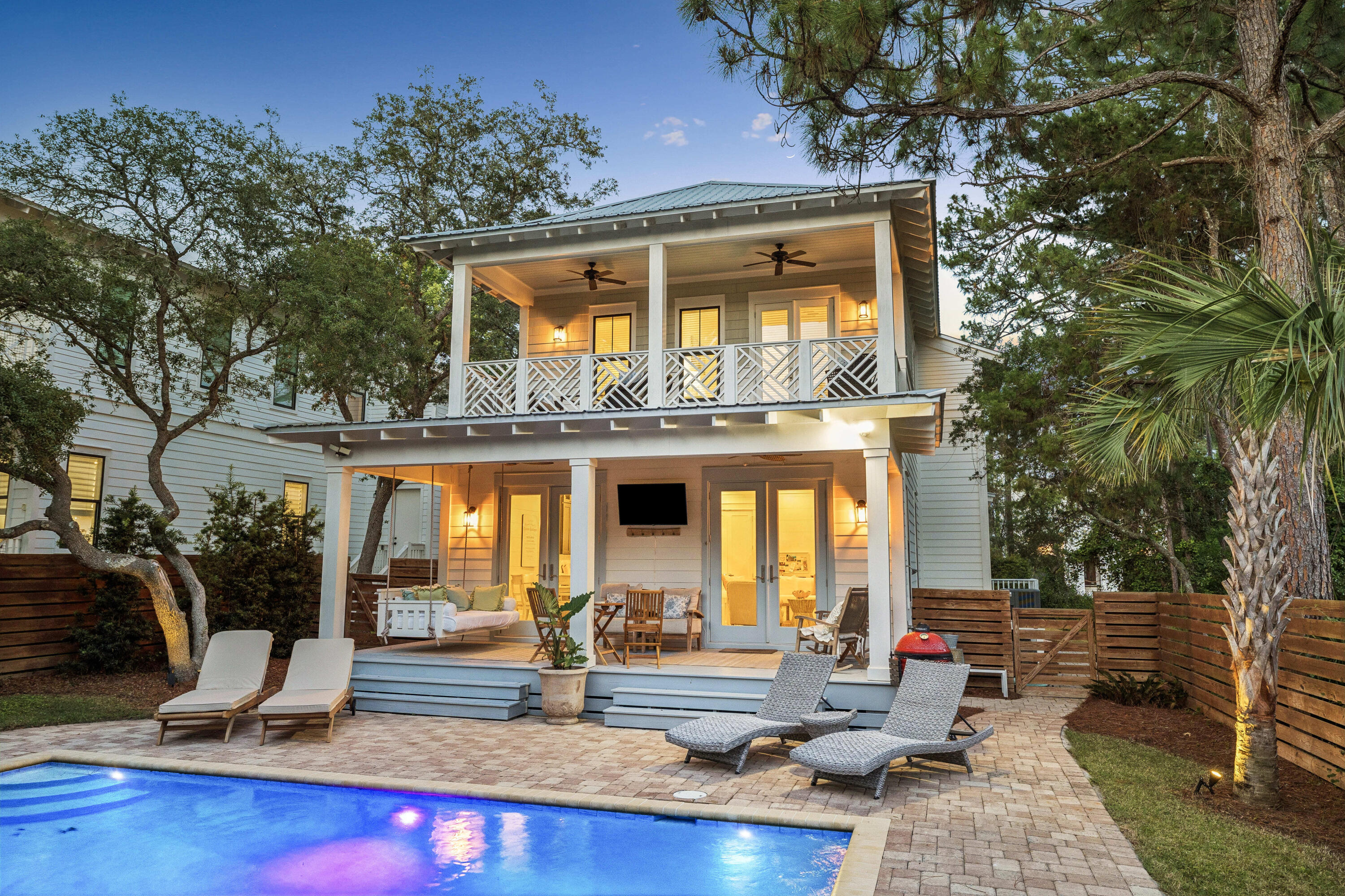 Welcome to 164 South Gulf Drive, a beautifully designed coastal residence tucked beneath a canopy of mature pines in the heart of Seagrove Beach. Blending timeless beach-house architecture with modern comfort, the home offers a refined yet relaxed lifestyle just moments from the Gulf of Mexico along the coveted Scenic Highway 30A corridor.

The light-filled interior features white-painted shiplap walls, wide-plank flooring, and an open-concept living area designed for effortless gathering and entertaining. The kitchen is appointed with custom cabinetry, quartz countertops, a generous center island, stainless steel appliances, and designer lighting that seamlessly connect to the main living and dining spaces. The primary suite offers a spa-inspired bath with dual vanities, a soaking tub, and a glass-enclosed shower, while additional guest accommodations include well-appointed bedrooms and a custom bunk room.

Outdoor living is centered around a private heated pool with paver decking and fully fenced grounds for added privacy. Covered porches, a hanging swing, and a second-level balcony overlooking the surrounding tree canopy create inviting spaces for relaxing and enjoying the coastal setting.

Additional highlights include a two-car garage and convenient access to nearby beach access points, dining, and shopping along 30A. This residence is well-suited as a primary home, second residence, or investment opportunity.