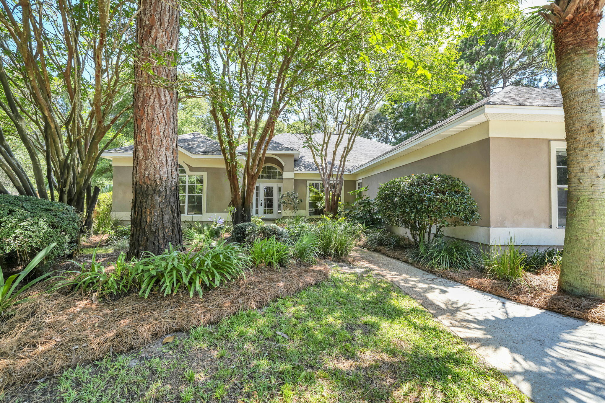Situated on highly sought-after Indian Trail, just moments from the sparkling waters of Choctawhatchee Bay, this spacious custom residence presents a rare opportunity to create your dream home in one of Destin's most coveted neighborhoods. Originally built as a Parade of Homes showcase, the property boasts distinctive architectural details and quality craftsmanship rarely found at this price point. While ready for cosmetic updates and your personal touch, the home's solid construction, functional layout, and prime location provide the perfect foundation for a stunning transformation.

The expanded floor plan showcases soaring cathedral ceilings, elegant tray ceilings, arched entryways, seamless tile flooring, and dramatic 12-foot sliding glass doors that fill the home with natural light. A cozy wood-burning fireplace adds warmth and character to the main living area.
Designed for both entertaining and everyday living, the home offers multiple gathering spaces, including a formal dining room, spacious family room, breakfast area, open-concept kitchen, wet bar, oversized utility room, and an expansive living room. The generous layout provides endless opportunities to modernize and customize while preserving the timeless charm and unique features that make this home truly special. With its desirable location, impressive square footage, and exceptional architectural character, this property is an outstanding opportunity to create a one-of-a-kind residence in the heart of Destin. Living on Indian Trail means enjoying one of Destin's most established and sought-after neighborhoods, celebrated for its beautiful homes, mature landscaping, and close proximity to Choctawhatchee Bay. Residents enjoy convenient access to the Emerald Coast's renowned white-sand beaches, world-class fishing and boating, championship golf courses, premier shopping and dining, and highly regarded schools. Whether you're searching for a primary residence, vacation home, or investment with lasting value, this exceptional location offers an unmatched lifestyle.

As a member of the Eagles Landing Homeowners Association, residents also enjoy access to the community pool, providing the perfect place to relax and unwind on warm Florida days.

Bring your creativity and vision to unlock the full potential of this hidden gem. With its desirable location, custom architectural features, and endless possibilities for modernization, this property presents a rare opportunity to create a spectacular coastal retreat in one of Destin's most coveted neighborhoods. Opportunities like this on Indian Trail are becoming increasingly rare--don't miss your chance to make this exceptional property your own.