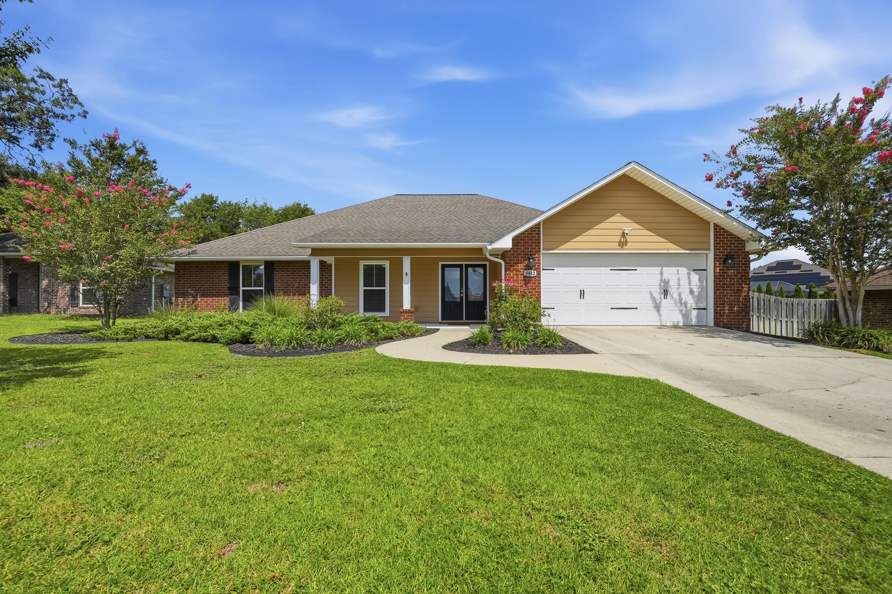 Welcome home to this beautifully maintained 4-bedroom, 2.5-bath home located in a desirable gated community just south of I-10. Situated on a level one-third acre lot, this move-in ready home offers an open-concept floor plan with 10-foot ceilings, generous living spaces, and thoughtful upgrades throughout. The spacious kitchen is designed for both everyday living and entertaining, featuring granite countertops, stainless steel appliances, a large center island with bar seating, under-cabinet lighting, a walk-in pantry, and ample cabinetry. The split-bedroom floor plan provides privacy, with three oversized guest bedrooms, each complete with walk-in closets, while the primary suite offers tray ceilings, french doors leading to the screened pool area, a large walk-in closet, soaking tub, and a travertine walk-in shower with frameless glass enclosure. One of this home's standout features is the convenience of two laundry rooms, including a second laundry area inside the primary suite, with the washer and dryer conveying. A dedicated office/flex room with french doors provides the perfect space for working from home, a playroom, or hobby room. Step outside and enjoy your own private backyard retreat. The screened-in heated pool, installed in 2019, features cool-coated concrete decking, a natural gas heater, two pool umbrellas, and a solar cover, making it the perfect place to relax or entertain year-round. The fenced backyard offers plenty of space to enjoy  while maintaining privacy. Additional upgrades include porcelain tile throughout the main living areas and bathrooms, wood-look porcelain plank flooring in the bedrooms, coated garage flooring, Rain Bird irrigation system, gutters, PEX Manibloc plumbing, smart home features, and a transferable termite bond. Roof and HVAC are 2017, and the water heater was replaced in 2023. This home truly has it all: space, style, smart upgrades, and an incredible outdoor living area. Schedule your showing today!