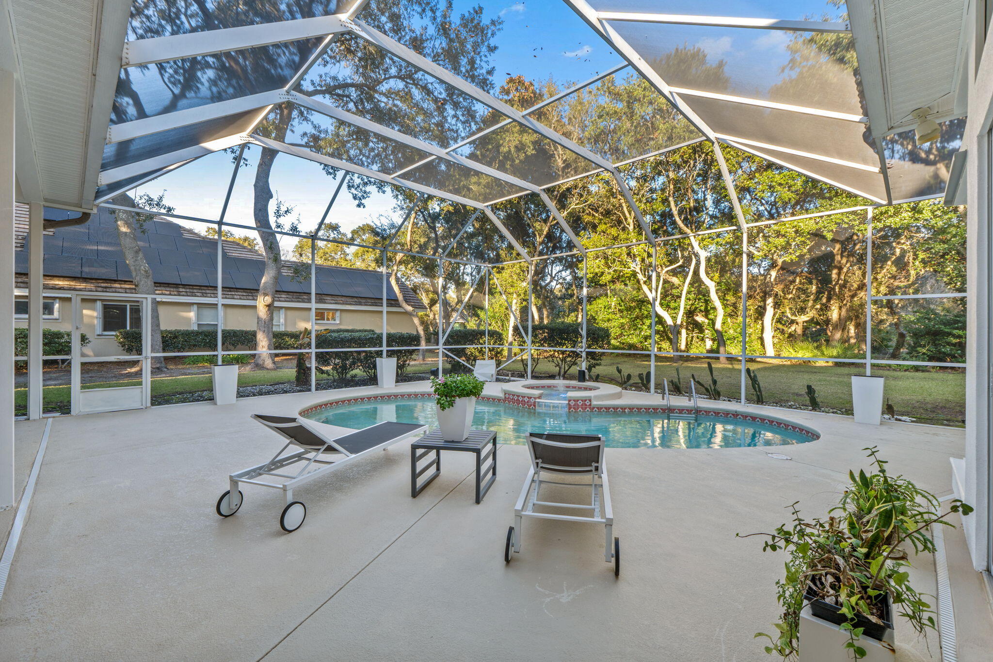 Experience refined coastal living in this beautifully remodeled 4-bedroom, 3.5-bath home nestled in the prestigious Kelly Plantation community. Designed with comfort and elegance in mind, this residence blends modern updates with timeless architecture to create an inviting retreat overlooking a private, enclosed pool.  Step inside to discover soaring ceilings and an open living and kitchen concept that fills the space with natural light. The thoughtfully designed split bedroom floor plan offers both privacy and functionality, ideal for families or hosting guests. Two spacious living areas, each with sliding doors; seamlessly connect indoor living to the serene pool views, creating the perfect atmosphere for gatherings or quiet relaxation.