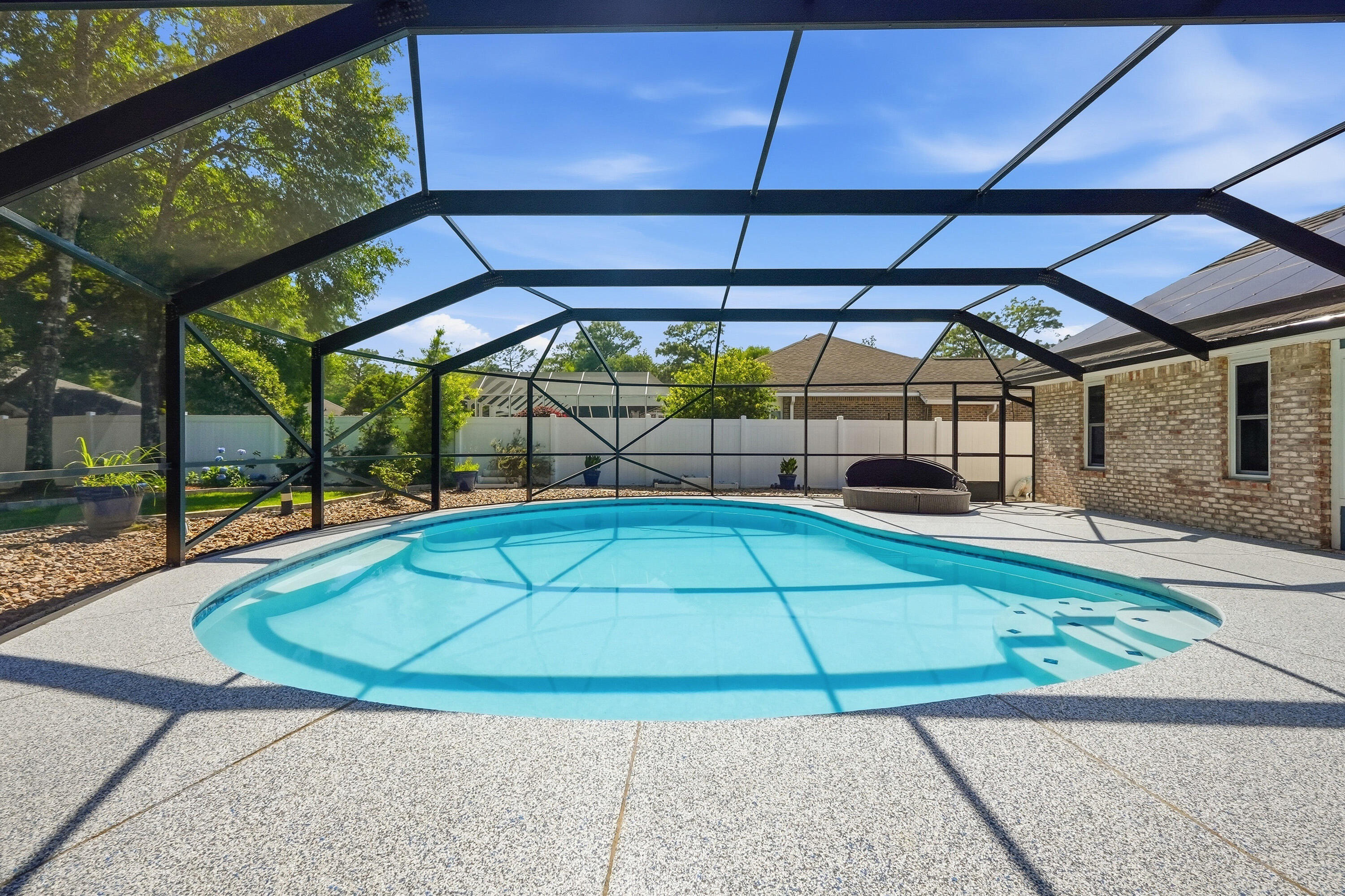 This exquisite home has been reimagined from top to bottom and offers comfort, quality, and convenience just minutes from Eglin Air Force Base. Situated on a quiet cul-de-sac, this property features a stunning circular paver driveway that adds both curb appeal and convenience. Inside, the freshly painted interior showcases updated bathrooms and a beautifully renovated kitchen with quartz countertops, gas appliances, and modern finishes throughout. Top-quality AC6-rated laminate flooring flows throughout the home with absolutely no carpet, offering exceptional durability, style, and easy maintenance. Designed with efficiency in mind, the home also includes solar panels, a tankless water heater, and a whole-home generator for added value and peace of mind. Step outside to your private backyard retreat featuring a sparkling saltwater pool with a screened enclosure, perfect for relaxing or entertaining year-round. Additional highlights include new hurricane-rated windows, a Level 2 EV charger, and a durable 50-year metal roof. Conveniently located near shopping, dining, schools, and the beautiful Emerald Coast beaches, this home offers the perfect combination of location, upgrades, and lifestyle.