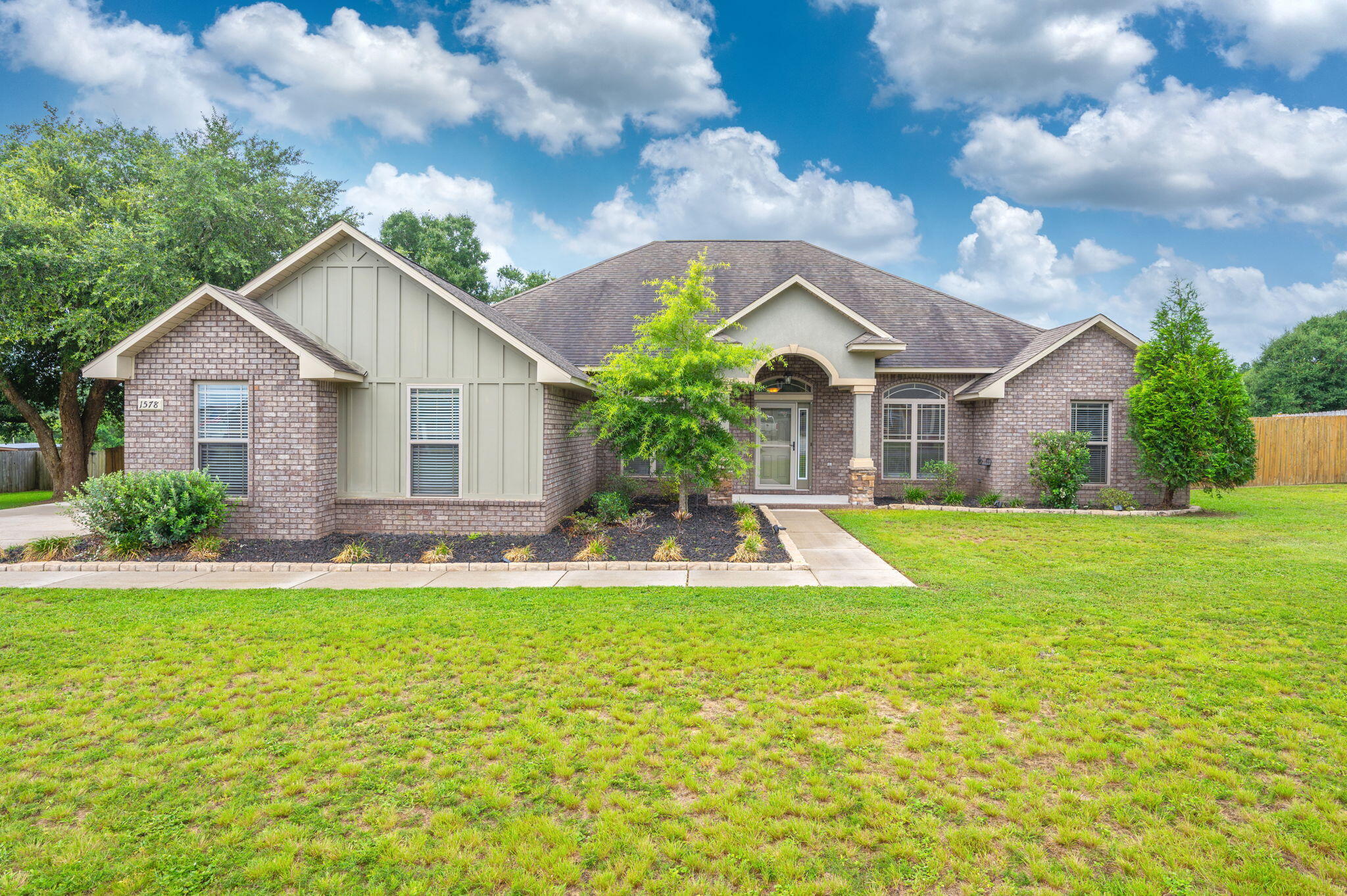 SELLER IS OFFERING $10,000 IN SELLER CONCESSIONS!

Welcome to this beautifully maintained 4-bedroom, 3-bath home in the desirable Mossy Oaks Plantation community. Situated on a spacious half-acre lot, this nearly 3,000-square-foot home offers the perfect combination of elegance, comfort, and functionality with a sought-after split floor plan and an impressive 3-car side-entry garage.

Step inside to soaring ceilings, vinyl plank flooring, crown molding, and abundant natural light that fills the open living spaces. The great room is highlighted by a tray ceiling and a cozy fireplace, creating the perfect gathering place for family and friends. Just off the foyer, you'll find a formal dining room along with a versatile flex room featuring French doors that's ideal for a home office, playroom, or additional living space. The kitchen is designed for both entertaining and everyday living, featuring granite countertops, stainless steel appliances, custom wood cabinetry, a wraparound breakfast bar, recessed lighting, and a large walk-in pantry. The adjoining breakfast area overlooks the backyard and flows seamlessly into the main living area, making this home perfect for hosting guests.

The private owner's suite is a true retreat, offering a spacious bedroom with a tray ceiling, an oversized ensuite bath with double vanities, a garden tub, separate shower, and generous walk-in closet space. Three additional bedrooms are thoughtfully arranged for privacy, including a separate guest suite with its own full bath--perfect for visitors, extended family, or multigenerational living.

Outside, you'll enjoy the fully fenced backyard with plenty of room for entertaining, children, pets, or even a future pool. The beautifully landscaped yard, side-entry garage, and oversized driveway add to the home's exceptional curb appeal.

Located just minutes from Schools, Crestview, Eglin AFB, Duke Field, and 7th Special Forces Group, this move-in-ready home offers the space, quality, and location buyers have been searching for.