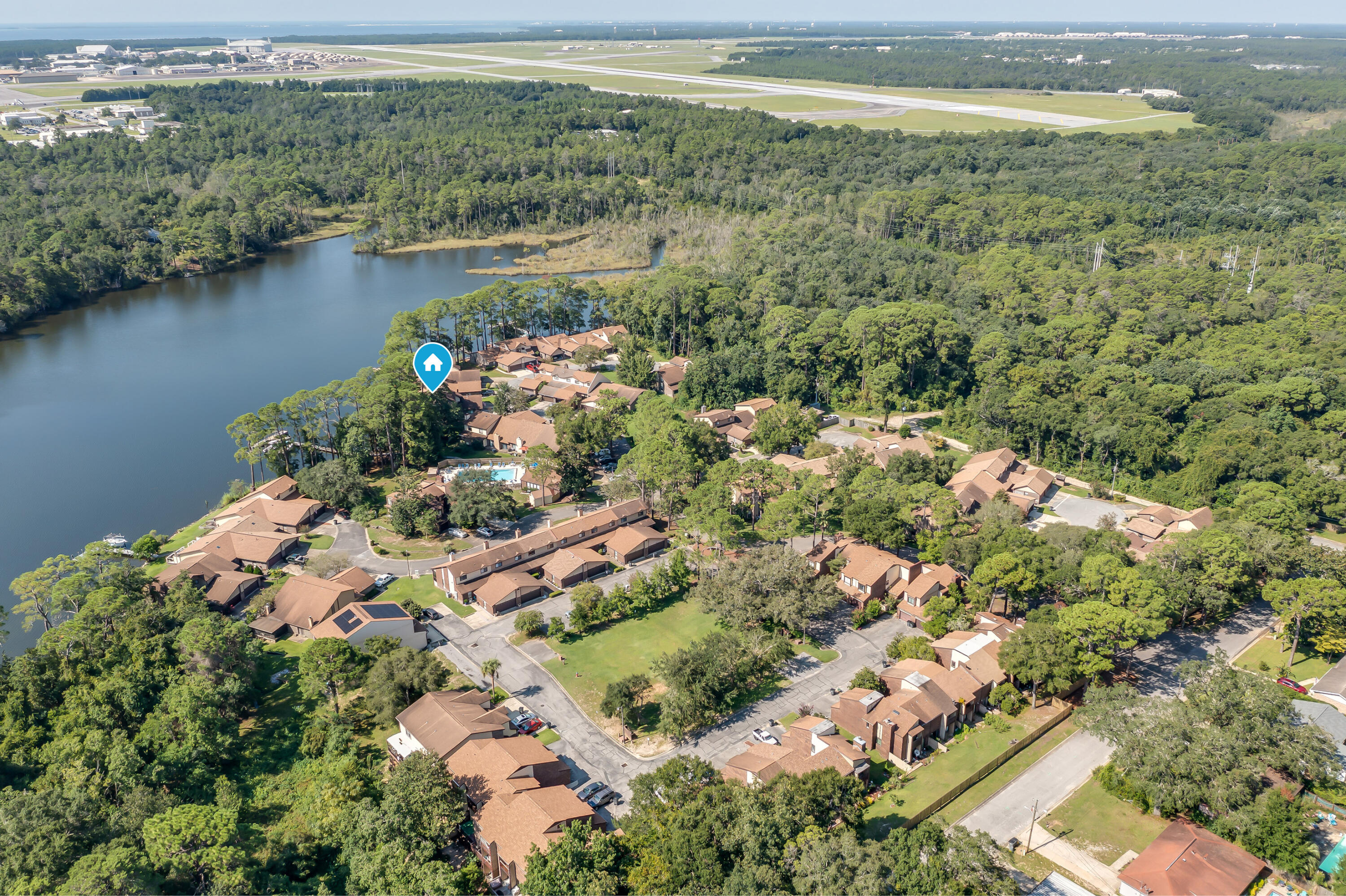 Welcome to your new waterfront community where boating, fishing and water sports are just outside your back door. Live only minutes from Eglin AFB in this sought after community with a waterfront community pool, clubhouse, workout room and a community boat dock (leased slips available). This property sits on Tom's Bayou which is a short boat ride to Destin's Crab Island. This open, and airy home offers gorgeous bayou views from the back porch. Downstairs features include a master suite with a full bathroom, a walk in closet and an additional half bathroom. Open kitchen and beautiful vaulted ceilings with a fireplace and double doors for gorgeous view of the water are key features as well. Upstairs presents a spacious loft for work or play, two bedrooms and a full bathroom. New roof and high impact windows were installed in 2024. All new carpet was just installed in the bedrooms and on the stairs in April. This home is a one of a kind in this area and with the beautiful water right outside your back door, you will enjoy the beauty of Tom's Bayou every day, ideal as a primary residence or a high-demand rental.