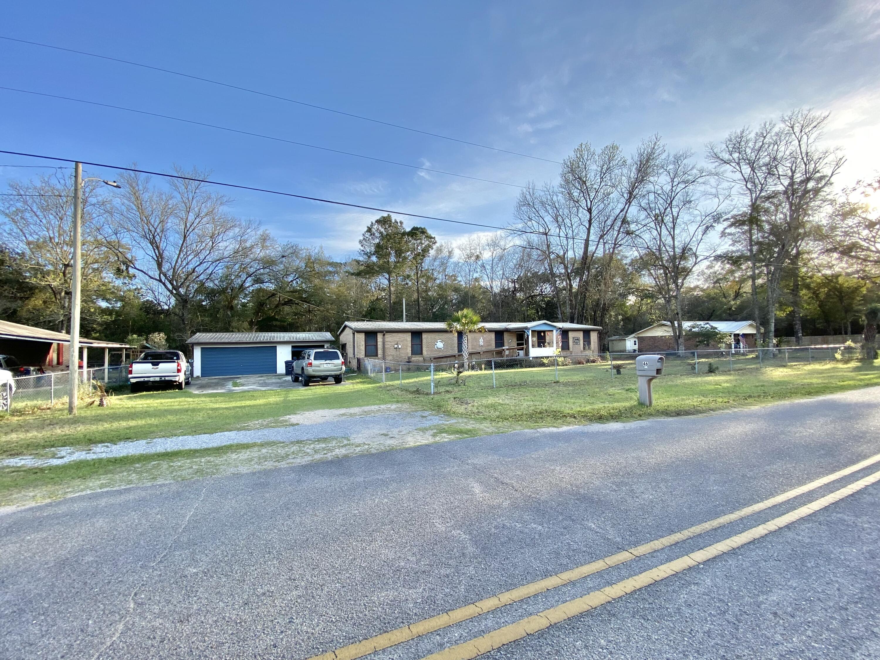 NO FINANCING AVAILABLE MUST BE CASH! The Mobile Home is a 1975 but the effective date is 1993 and deemed Real Property. SPACIOUS 4 LOT PARCEL with a larger double wide mobile home located in a charming community just off of Bay loop Rd. Just minutes to downtown Freeport, Freeport Regional Sports Complex at Hammock Bay, Shipyard Boat Ramp (AKA Four-Mile Point Public Boat Launch), and Freeport Marina and Yacht Club! This home offers ALL BRICK SIDING, 3 bedrooms/ 2 bath large floor plan, separate living and family room, formal dining room, a Florida room, and a completely fenced in yard providing ample privacy. RV, BOAT or both you have the space for your toys! 2 CAR DETACHED GARAGE made of concrete block with 2 shed or workshop areas. METAL ROOF 2020, all-inclusive AC/Heater combo just a year old and newer water heater. With its proximity to the Beach and ample parking could be a great short-term rental! Does need TLC like flooring, inside paint but with that can be fresh and new! You can really have the best of both worlds; quiet and seclusion yet just a short drive to all the action (beaches, shopping, dining, and entertainment) of the emerald coast. Buyer and buyers agent to verify all dimensions and anything deemed important.