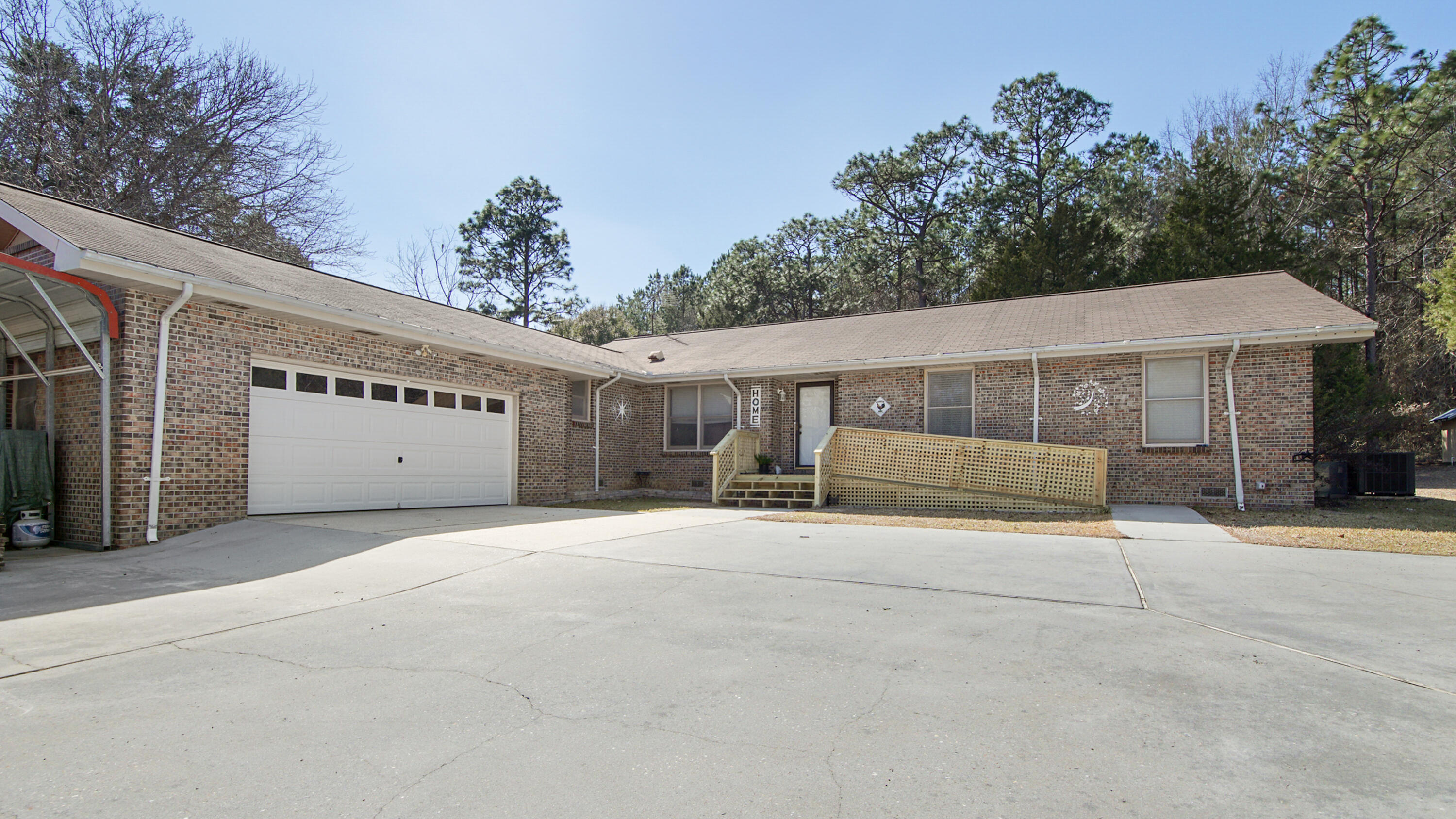 Great home in the country with tons of room inside and out! Sitting on 2.47 acres with tons of blueberry, fig and pecan trees. Home offer a large foyer that opens to a great size living room that includes a large fireplace. Home includes a large kitchen with tons of cabinets and counter space for cooking. Home is a 3BR/2BA with an office that can easily be converted to a 4th BR. Off the kitchen you will find a large laundry area that includes a half bath for guest and also access to exit out to the rear covered screened in porch and fenced yard. Home includes a great master suite with a huge walk in closest and tons of storage in the bathroom. The additional 2 bedrooms offer great size plus an additional full bath. Home has recently been painted on the interior, new trim, new sink and vanity in master bathroom, new flooring in master bath, as well as a brand-new septic tank installed. Home has tons of storage, paved driveway, garage and carport. Great location on a paved road with easy travel time to Crestview and town all while quite living!