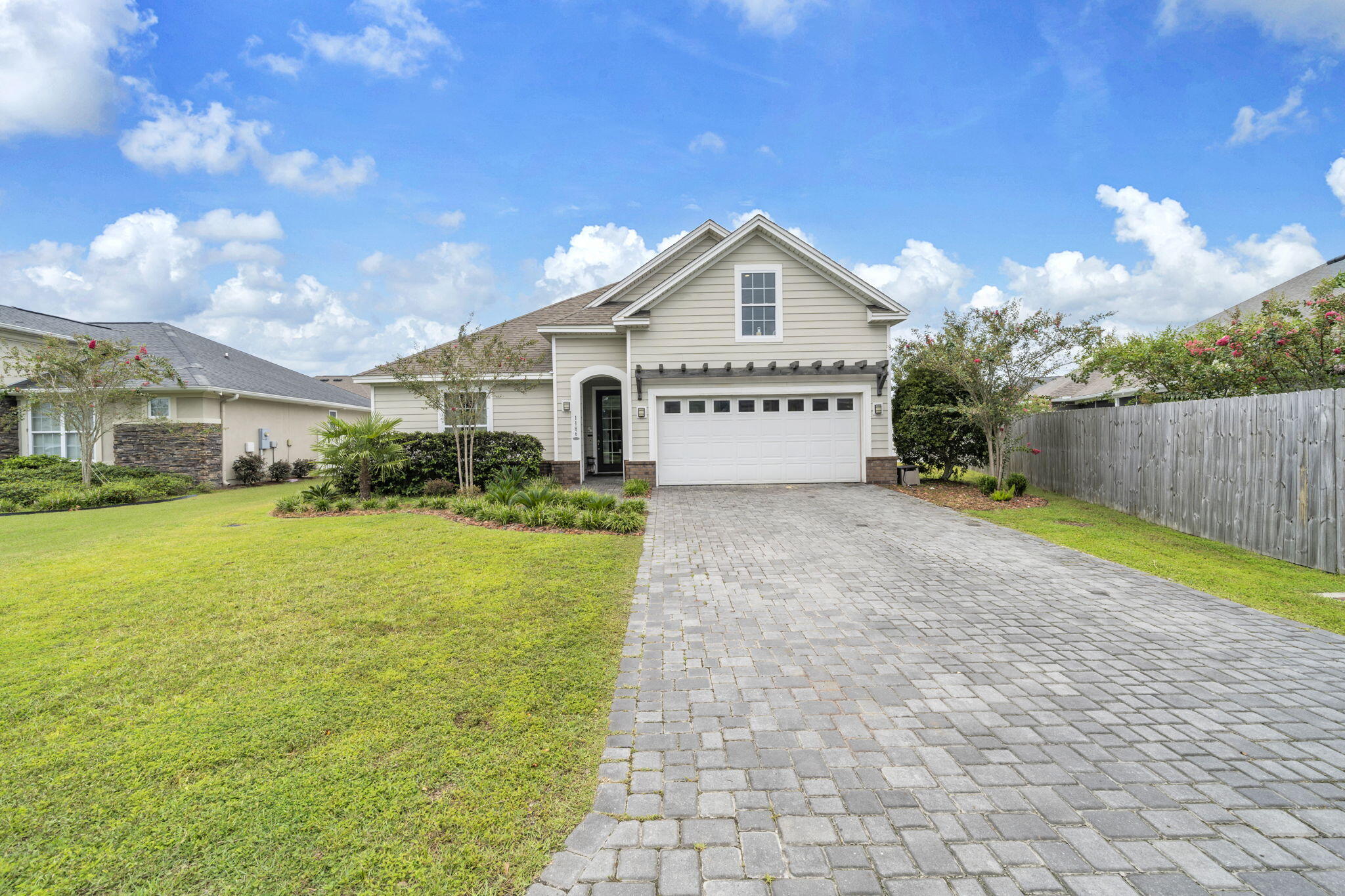 VA ASSUMABLE LOAN AT 2.75% for a qualified buyer! That alone makes 1186 Eisenhower Circle worth a closer look. This 3-bedroom, 2-bath home with a bonus room in Lynn Haven, Florida offers more than 2,200 square feet, beautiful hardwood flooring, a fully fenced backyard and an expanded outdoor living space designed for enjoying Florida year-round. Built by Arthur Rutenberg, this home has been beautifully maintained and thoughtfully updated with an open floor plan that gives you plenty of room to gather and spaces to spread out.
One of the updates you'll notice immediately is the flooring. Hardwood has been added to all three bedrooms to match the existing hardwood throughout the main living areas, giving the home a seamless look with no carpet. Coordinating LVP was added to the bonus room, creating flexible space for an office, media room, playroom or additional living area. Crown molding, tray ceilings, recessed lighting, custom window treatments and large windows add to the bright, finished feel throughout the home.
The kitchen is right at the center of it all, opening to the living and dining areas and featuring white cabinetry, granite countertops, stainless steel appliances, a large pantry and an oversized island with plenty of seating. It's an easy layout for everyday life and even better when everyone ends up gathered around the kitchen.
The primary suite offers a spacious bedroom, walk-in closet and private bath with double vanity and tiled walk-in shower. Two additional bedrooms and the bonus room give you plenty of options for how you use the space.
But don't stop at the back door. The outdoor living space has been significantly expanded with a large patio, sail coverings for shade and added privacy, creating a great place for grilling, dining or simply relaxing outside. Even with the expanded patio, there's still a large, fully fenced backyard with plenty of room to enjoy.
Additional features include a two-car garage with Tesla/EV charger, paver driveway, brick accents, attractive landscaping and a tankless water heater.
A 2.75% assumable VA loan, more than 2,200 square feet, no carpet, bonus room, fenced backyard and expanded outdoor living--1186 Eisenhower Circle offers a combination that's hard to overlook. Come see how well this Lynn Haven home lives.