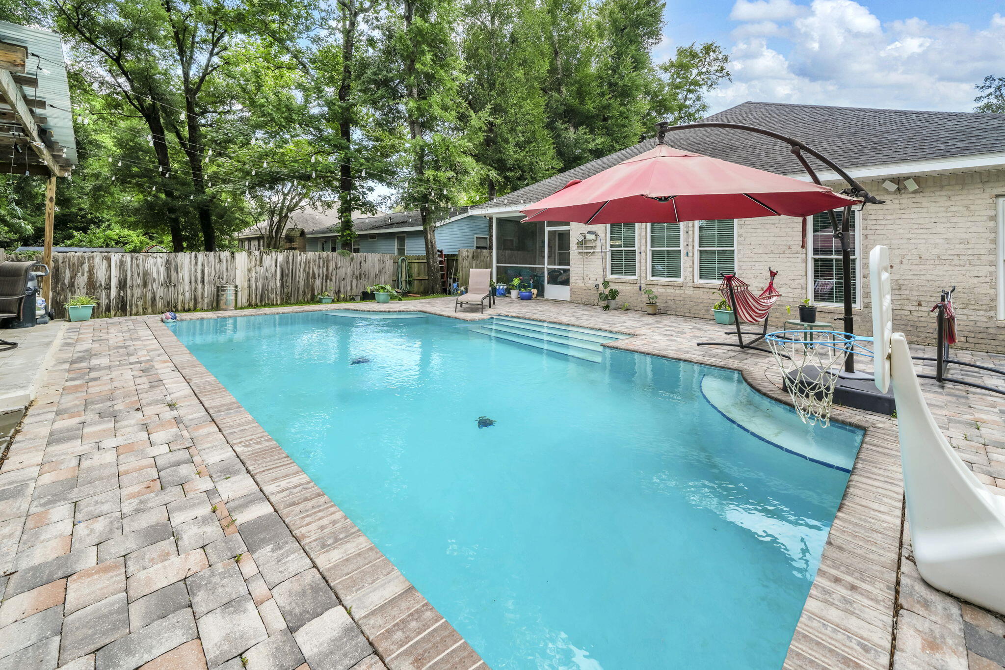 **UNDER CONTRACT WITH A 72 HOUR KICK OUT CLAUSE** This modern Craftsman-style 4-bedroom, 2-bath home with a beautiful inground heated POOL sits on .41 acres in the heart of Niceville. Meticulously maintained, this all-brick residence features a welcoming front porch, screened back porch, split floor plan, walk-in closets, quartz countertops, custom soft-close shaker-style all-wood cabinets, slate-finish GE appliances, a walk-in pantry, and an oversized island with breakfast bar.
The open-concept layout is enhanced by luxury vinyl plank flooring in the bedrooms and ceramic tile throughout the living room, kitchen, and dining area. Located in a quiet neighborhood, the home also offers a spacious backyard rarely found in the area, a beautiful heated pool, EV charger, epoxy-coated garage and front porch floors, and an additional driveway for your boat or extra vehicle parking. This home is ready for your family to create lasting summer memories with its spacious backyard and beautiful heated pool! Conveniently located in an A+ School district and close to the beaches of Destin, Eglin AFB and 7th Group.