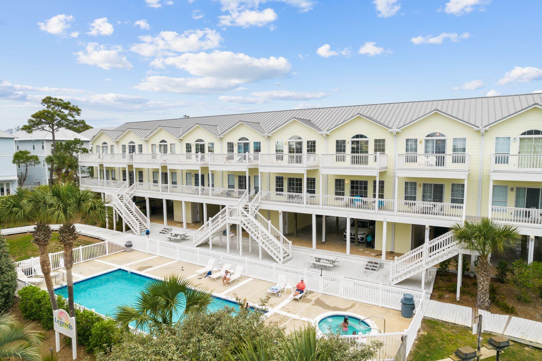 Just a short walk from two quiet beach access points, this updated two-bedroom, two-and-a-half-bath townhome offers an easy 30A lifestyle with generous living space, resort-style amenities and shops and restaurants within walking distance. The residence spans two levels above covered parking for two vehicles, with an open main living area featuring nine-foot ceilings, abundant natural light and a kitchen with breakfast bar and pantry.  Upstairs, both bedrooms feature private ensuite baths and ample closet space. The primary suite adds a cathedral ceiling, private balcony overlooking the pool and bath with a separate soaking tub and shower. Recent improvements include updated interiors plus replacement windows and doors throughout the development, with the assessment already paid.  A swimming pool, hot tub, tennis court, sand volleyball court, grilling and picnic areas and dedicated storage for beach gear round out the amenities. With the beach close by and 30A dining and shopping at Gulf Place within an easy stroll, this well-positioned townhome offers an appealing option for a second home, full-time residence or investment property.