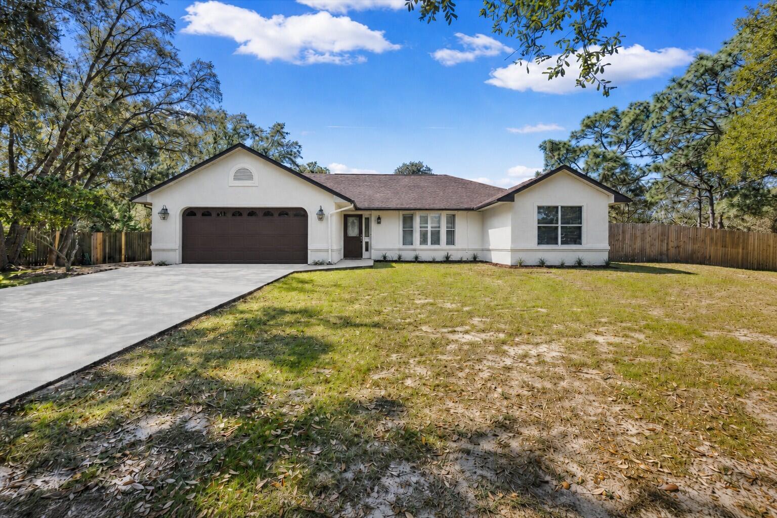 Rare opportunity in Holley by the Sea! Situated on an oversized, nearly one-acre cul-de-sac lot, this 4BR/2.5BA home offers a private backyard backing to a wooded preserve, mature oak trees, a fully fenced yard, and side-gate access. There is plenty of room for boat, RV, and trailer storage while still leaving space for a future pool, garden, or outdoor entertaining area.

Inside, the spacious family room features vaulted ceilings and plantation shutters. The kitchen includes a large breakfast bar, skylight, and an open layout connecting to the main living area. The home offers 2,298 sq ft of living space per prior appraisal, including the enclosed Florida room, ideal for an office, gym, hobby room, or additional living space.

Recent updates include fresh interior paint, HVAC (2025), and water heater (2022). A new roof will be installed prior to closing. The garage features upgraded interlocking floor tiles and a custom two-tone finish. A separate shop building with electricity adds valuable space for tools, hobbies, or storage. All appliances convey, including a new refrigerator, washer, and dryer (2025).
