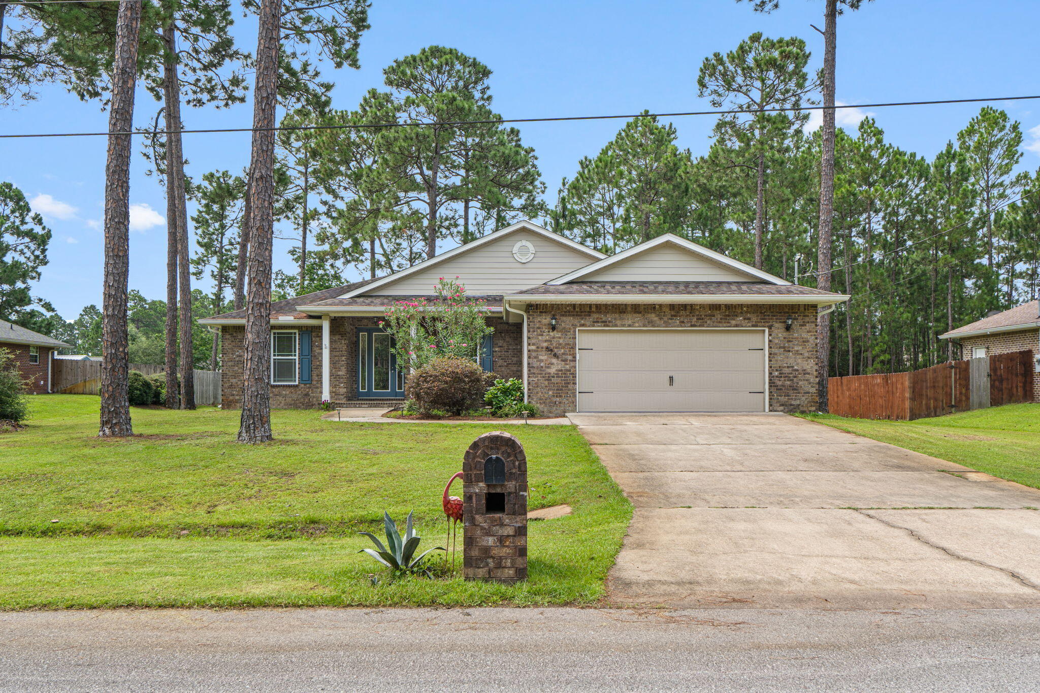 Welcome to this beautifully crafted 4-bedroom, 2-bath custom home located in the highly desirable Holley by the Sea community. From the moment you step inside, you'll appreciate the abundance of natural light and the inviting design.

The spacious living room features tray ceilings and recessed lighting that continues into the kitchen, creating a bright and welcoming atmosphere. The chef's kitchen offers an abundance of cabinetry, granite countertops, stainless steel appliances, and plenty of workspace for cooking and entertaining.

Luxury vinyl plank flooring flows throughout most of the home, providing both beauty and durability. The spacious primary suite is a relaxing retreat with a large walk-in closet and an en-suite bath featuring a double vanity, garden tub, and beautifully tiled walk-in shower.

The oversized laundry room is thoughtfully designed with additional storage, a utility sink, and a Whirlpool front-loading washer and dryer that convey with the home.

Enjoy year-round comfort in the heated and cooled Florida room overlooking the private backyard, which extends well beyond the tree line. Plenty of room to have a pool! Survey in documents.

Additional upgrades include a Culligan water treatment system, Ring doorbell security system, sprinkler system, and gutter guards to keep the leaves out! Ownership includes membership to the Holley by the Sea Recreation Center, featuring multiple swimming pools, a fitness center, tennis courts, basketball courts, pickleball courts, playgrounds, walking trails, and access to a boat launch on Santa Rosa Sound, along with many additional recreational amenities. 
Conveniently located just minutes from Navarre's sugar-white beaches, shopping, dining, top-rated schools, and Hurlburt Field. This move-in ready home combines quality craftsmanship, modern finishes, and an exceptional lifestyle. Don't miss your opportunity to make it yours!
