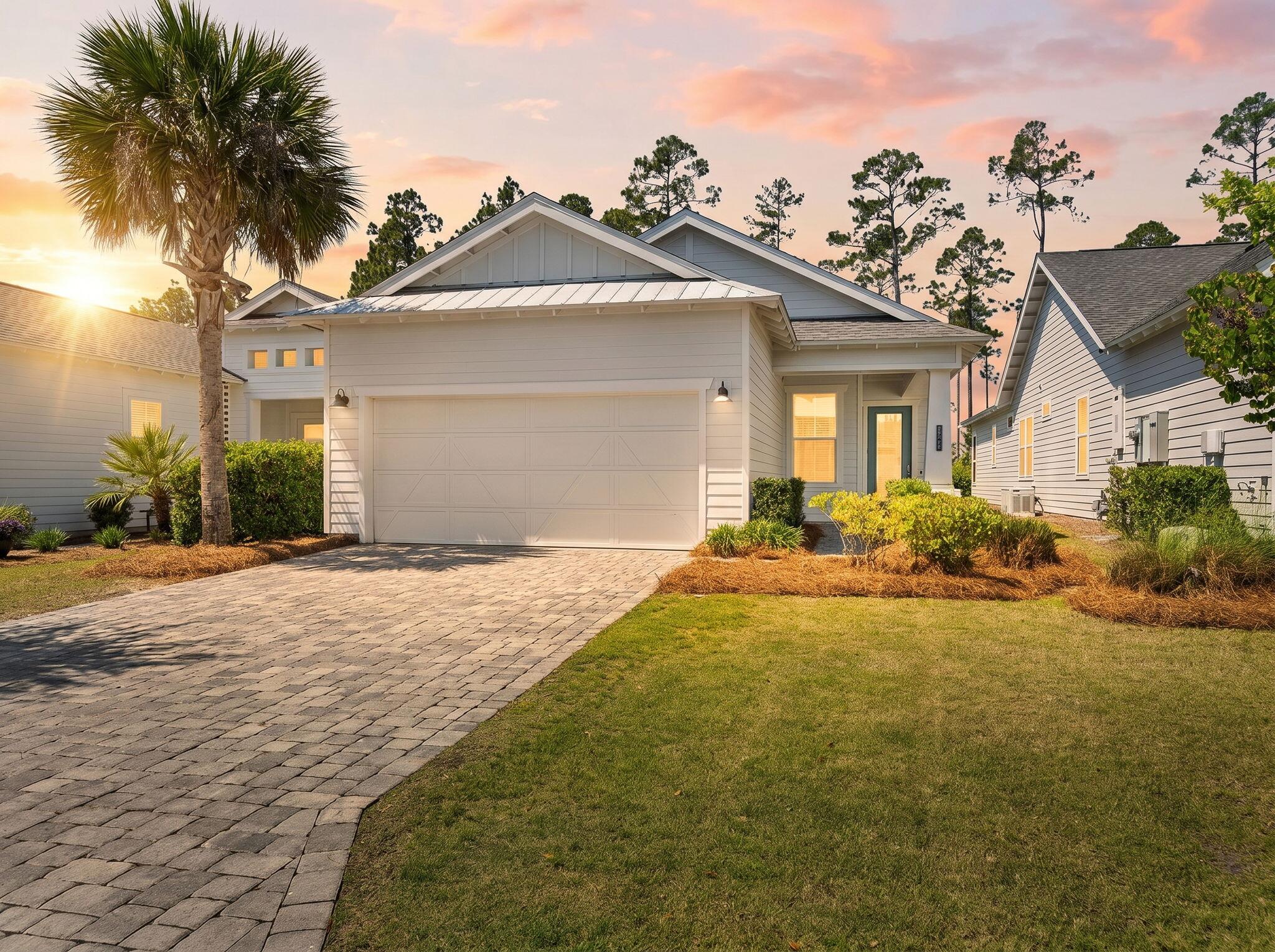 Nestled within the coveted NatureWalk at Watersound Origins, this impeccably designed 2022-built Clearwater floor plan blends coastal sophistication with everyday luxury. An open-concept great room and dining area features soaring tray ceilings, shiplap accent walls, and wide-plank hardwood floors. The chef's kitchen shines with white shaker cabinetry, brushed gold hardware, herringbone tile backsplash, stainless appliances, gas range, and a generous island with breakfast bar. The primary suite overlooks the covered lanai and offers dual vanities, a glass-enclosed shower, and a custom walk-in closet. A private second bedroom wing plus additional flex spaces serve as a home office, playroom, or guest retreat. Step outside to a private pool with travertine decking, outdoor kitchen, and serene pine-tree backdrop. Residents enjoy resort-style amenities including a community pool, clubhouse, fitness center, playground, and golf - all minutes from the sugar-white sands of 30A.
