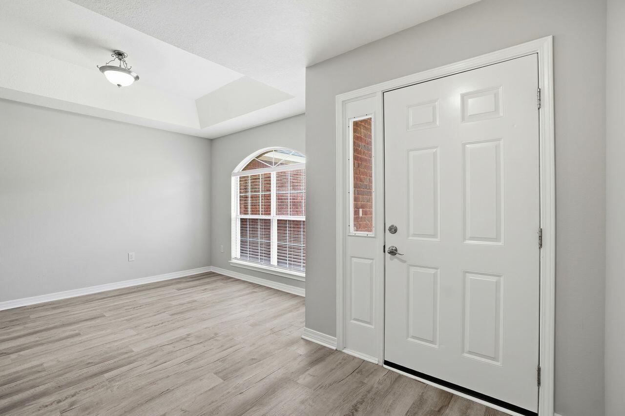 Once inside the front door, this home features all new and neutral laminate flooring throughout. To the 
right is a designated dining area that offers space for all your family gatherings which is open to the living 
room and features a warm cozy fireplace. Beyond the living room to the right is the kitchen with new 
granite counter tops, newly painted cabinetry and an eat-in area with bay windows. The master bathroom features a new vanity with double sinks, subway tile backsplash, and a tub/shower combo. To complete the  master bedroom is a  large walk in closet. The guest bedrooms are located on the other side of the home and are separated by a guest bath. Also adding to the appeal of this home is nearly everything on the 
interior has been replaced. New stove & refrigerator, new flooring throughout, fresh new paint throughout, all new 
lighting fixtures, all new outlet receptacles, all new light switches, new electrical panel, new vanities and 
fixtures, new counter tops, and new door knobs. The seller has had the septic pumped and inspected 
along with a fireplace inspection and new fire box installed. This home sits on .40 acre giving you plenty of outside space also. Roof - 2021, HVAC - 2022, Water Heater - 2016.  Don't miss this one!