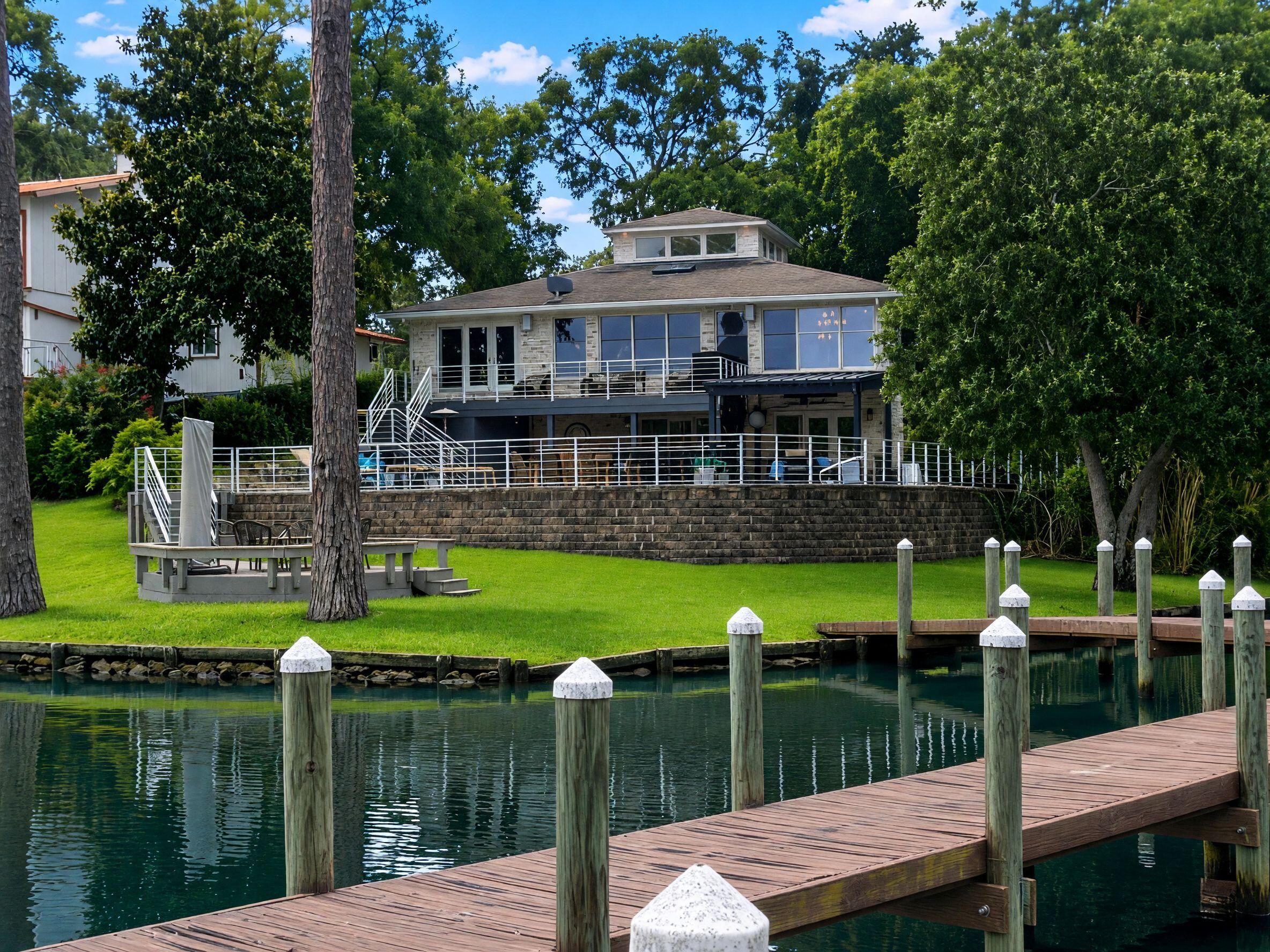 This is truly a one of a kind bayou estate--complete with pool, dock, and unforgettable views. A rare opportunity to own your forever waterfront retreat.

Tucked away at the end of a quiet cul de sac along the protected waters of Cinco Bayou, this beautifully designed 4BR/4BA home offers over 3,300 sq. ft. of comfortable luxury--and nearly 159 +/- feet of breathtaking bayou water frontage to enjoy every single day. 

The outdoor living spaces set the tone for relaxation and fun. An upper level deck, a covered lanai, a sparkling pool, outdoor kitchen, terrace level kitchen, bar, and TV all come together to create a private, resort style oasis ideal for gatherings large or small. 

Step down to the lush green lawn and you'll find an additional seating deck overlooking the water, plus a deep water dock with a covered slip and electric lift. The adjacent shallow water canal is also deeded to the property almost surrounding the rear of the property with stunning water views.

Inside, the main level welcomes you with rich hardwood floors and sweeping bayou views framed by a wall of windows. This floor features the primary suite, a guest room, office, dining area, and a chef's kitchen outfitted with high end appliances. 

The terrace level adds even more flexibility with a second master suite and an additional bedroom/office/family room--all with easy access to the pool deck and backyard.

(see more) Every corner of this home is designed to embrace the beauty of waterfront living while offering privacy, comfort, and exceptional spaces for entertaining.
