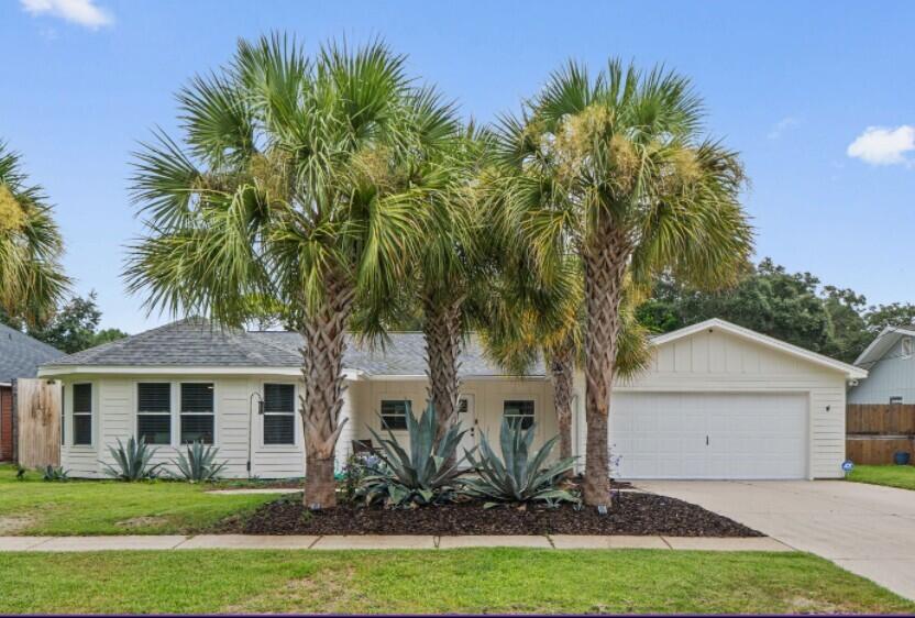 Welcome Home! Stunning Contemporary Home in Lakeside Village. This exceptional home boasts modern elegance positioned in one of Destin's well-established and desirable neighborhoods. You will notice as you pull up, the immediate curb appeal - the almost ¼ acre lot is beautifully landscaped with an abundance of palm trees that just embodies coastal living.  
Located minutes from Destin Harbor and Crab Island, this property offers a tranquil paradise with easy access to the best Destin has to offer.   Henderson Beach State Park, with its white sand beaches and nature trails, is just 3 miles away. Boating enthusiasts can head to Joe's Bayou Boat Launch, only 2 miles away, for easy access to Destin's beautiful waters. If you're a golf fanatic, you will enjoy the Indian Bayou Golf Club, only 3 miles from home.  
The home seamlessly flows from room to room with a fireside living room with cathedral ceiling, dining area and connected kitchen. You'll notice crown molding in every room, newer fixtures LVP throughout main living areas and tile in the two bathrooms. The living room is light and bright and just invites you to sit by the woodburning fireplace and relax. The beautifully appointed kitchen is the heart of the home, showcasing Samsung & KitchenAid appliances, black granite countertops, custom tile backsplash and maple cabinets make cooking a chef's dream. Retreat to a spacious primary suite with custom walk-in closet with cedar wall for decorative accent and a luxurious en-suite bathroom featuring dual vanities with glass tile counters, a separate two-person, glass-enclosed marble tile shower with regular showerhead, rain showerhead and two massagers. A main bath with marble tile and two more bedrooms, one very generously sized - large enough for two king beds and one with a gas fireplace, large walk-in closet and sliding door access to the backyard pool complete the home. 
Step out to your backyard oasis with in-ground saltwater Gunite pool with oxygenator, sun edge and seated ledge, surrounded by a custom large paver patio perfect for soaking up the Florida sun or unwind from the day in your personal hot tub.  The backyard has luscious professional landscaping with an irrigation well and sprinkler system with bubblers for easy maintenance, an open patio with a gas firepit, a workout area, an 8x12 outdoor shed, an outdoor shower and an 8-foot fence for extra privacy and safety. Whether hosting pool parties or neighborhood barbeques, your entertaining abilities will be limitless here.   
All major systems have been covered for your peace of mind.  Major improvements include Hardie board siding 2021, windows and doors -hurricane 5 rated - installed in 2022, Roof 2020, HVAC 2023, and tankless water heater 2021.  Enjoy life with NO HOA. Short-term rentals are restricted in this neighborhood.  For additional peace of mind, alarm system and outdoor security cameras are installed and convey. This is more than a home; it's the perfect place to live, work, and play. Don't miss this rare opportunity to own your piece of paradise in Destin!