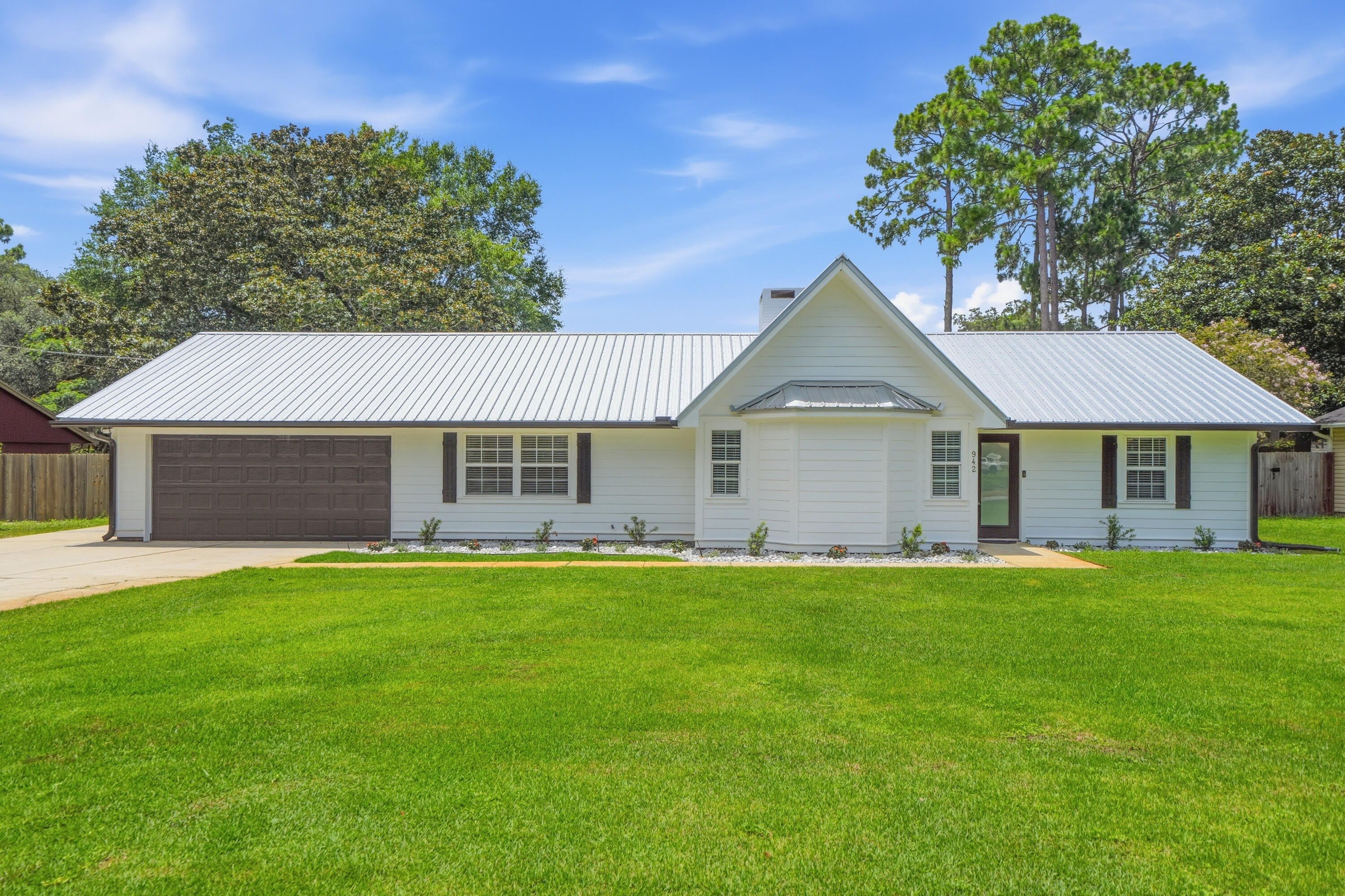*Vacant and Available as of 8/14* PETS ARE ALLOWED BUT RESTRICTIONS APPLY and a nonrefundable pet fee will be required. NO CATS ALLOWED. Welcome Home Sweet Home to this beautifully updated 3BR/2BA/1-Story home that's nested within Pinewood Estates off Bayshore Drive in south Niceville! Pinewood Estates is a NO HOA community that features street lights, sidewalks, and has only one entrance/exit! The public & free boat/jet ski/paddle board/kayak/canoe launch on Pin Oak Circle is less than half a mile from this home! Enjoy being able to have a 2-car garage, 6-car driveway for ample parking spaces, and a 1-car side driveway space for an extra parking spot to store a car, boat, RV, or an enclosed/open trailer! This home provides the perfect amount of space within its 1,612 square feet. The split floorplan and high ceilings in the living room & dining room make this home feel and live much larger than it actually is! Enjoy having no carpet and only LVP througout all main areas, bedrooms, & closets and tile in both bathrooms & laundry room. The kitchen & bathroom countertops are granite and all the cabinets  have all been painted white. The spacious laundry room is located next to the kitchen and provides ample space and storage to use as a pantry as well as a laundry room. Washer & dryer hook ups are available, but you will need to provide your own washer & dryer. The fireplace is located in the center of the home & acts as a wall that separates the living room from the dining room. It is a wood burning fireplace that has a closed flue and will not be allowed to be used by tenants. There is a brand new side- by-side refrigerator/freezer in the kitchen and another side-by-side refrigerator/freezer the garage for extra refrigeration/freezer storage. Inside the home, all of the walls are painted with the neutral color, "Revere Pewter," by Benjamin Moore. There is a 2-car garage with freshly painted white walls and trim. Inside the garage is an attic access with pull-down stairs to it. The exterior of the home has hardie board siding that has been painted white. The front door, garage door, and shutters have been painted black. Freshly installed black gutters have been placed on the front and back sides of the home. The backyard is HUGE and fully privacy fenced with gates on both sides of the house. Two of the three sides of the fenced backyard were just recently replaced. The well pump irrigation is located in the backyard and only irrigates the front yard. There are no trees in the front or backyard which helps provide very easy lawn maintence for you to do. This home and it's location are very desirable and within very close proximity to all that Niceville has to offer! Inquire today before it's too late!