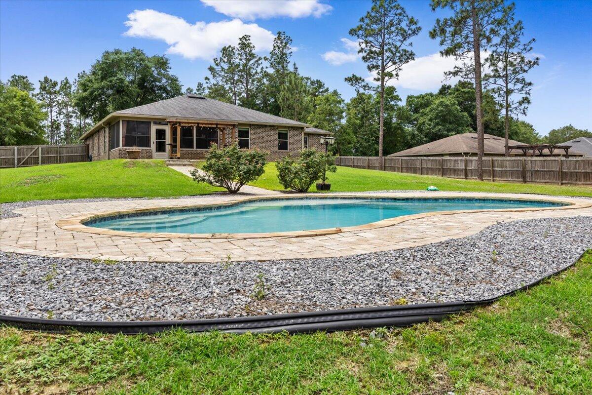 POOL HOME ON OVER AN ACRE IN YELLOW RIVER PLANTATION!
Experience the perfect blend of peaceful country living and modern convenience in this spacious custom-built home situated on over an acre in the highly desirable Yellow River Plantation community of Laurel Hill, Florida. Offering exceptional value and endless potential, this 4-bedroom, 3-bathroom home features a versatile floor plan designed for today's lifestyle.
Inside, you'll find a dedicated home office, formal dining room or flex space, spacious living room, and a separate den featuring a custom barn door entry--ideal for a media room, playroom, or additional living space. The oversized primary suite and generously sized secondary bedrooms offer abundant closet space, while the Jack-and-Jill bathroom layout provides separate vanity and shower areas for added functionality.
The heart of the home is the expansive kitchen featuring granite countertops, extensive cabinet storage, a large center island with electrical outlets, breakfast bar seating, built-in desk area, and an oversized walk-in pantry. The adjoining living area showcases a gas fireplace with custom built-ins, creating a warm and inviting gathering space.
Step outside and enjoy your private backyard retreat complete with a sparkling pool, updated gazebo, fully fenced backyard, and plenty of room to relax, entertain, garden, or enjoy the outdoors. The oversized driveway accommodates approximately 10 vehicles, offering plenty of parking for guests, recreational vehicles, boats, or additional family vehicles.
Additional upgrades include gutters, a security system, custom built-ins, updated lighting fixtures, kitchen pendant lighting, and updated ceiling fans in the living room, dining room, and primary suite.
Yellow River Plantation offers residents the charm of a custom-home community with the tranquility of country living. Neighborhood amenities include two stocked fishing ponds, two scenic nature trails, and a community playground. Enjoy the space and privacy of acreage living while remaining conveniently located near shopping, dining, schools, and major commuting routes throughout Northwest Florida.
This location is especially attractive for military personnel, offering convenient access to Eglin Air Force Base, Duke Field, Hurlburt Field, 7th Special Forces Group, and other military installations throughout the Florida Panhandle. Whether you're searching for a military relocation home, a pool home with land, or a spacious Northwest Florida property with room to grow, this home checks all the boxes.
Being sold AS-IS (new flooring, paint & minor cosmetic touch-ups needed), this property presents an outstanding opportunity to own one of the best values currently available in Yellow River Plantation. Come discover the lifestyle, space, and potential that make this community one of Northwest Florida's hidden gems.
