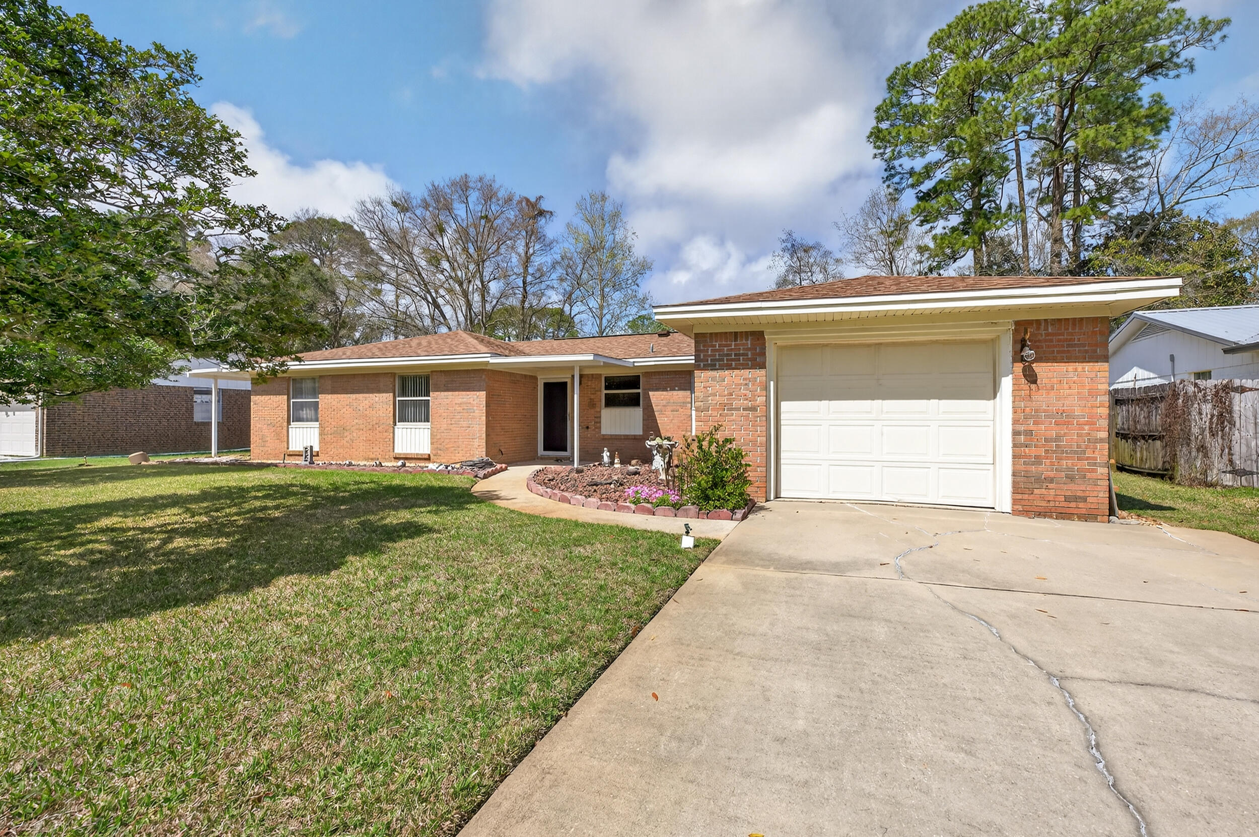 Tucked into the heart of Niceville, this updated 3-bed, 2-bath home blends comfort, smart improvements, and an unbeatable central location. Best of all, the seller will replace the roof prior to closing for added peace of mind.
Inside, wood laminate flooring flows through the living room and hallway, and a spacious dining room doubles as a flex space for an office, playroom, or second living area. The kitchen shines with gray cabinetry, granite counters, tile flooring, and newer white appliances, including a gas range. Both baths feature updated cabinets, granite, and newer fixtures, while the bedrooms enjoy brand-new carpet. Dependable systems include a gas tankless water heater (2007) and HVAC (2014). The owners even removed the dining room paneling and added new drywall and trim--truly move-in ready.
The location seals the deal. Niceville is served by the highly rated Okaloosa County School District, an 'A'-rated district year after year. Military families enjoy a quick commute to Eglin AFB (about 10 minutes), with Hurlburt Field and Duke Field close by. Add Florida's no state income tax and the Emerald Coast's white-sand beaches just minutes away, and it's easy to see why Niceville is so sought after.
 and the flooring will need to be replaced, giving buyers the opportunity to personalize the space. All of the windows were updated with Hurricane rated windows. 

Outside, enjoy a large covered back porch overlooking a well-maintained yard with St. Augustine grass and mature persimmon fruit trees, and pear trees. A portable storage shed provides additional space for tools or lawn equipment. Conveniently located near schools, parks, shopping, and Eglin Air Force Base, this home offers a great opportunity to enjoy life in the heart of Niceville.
