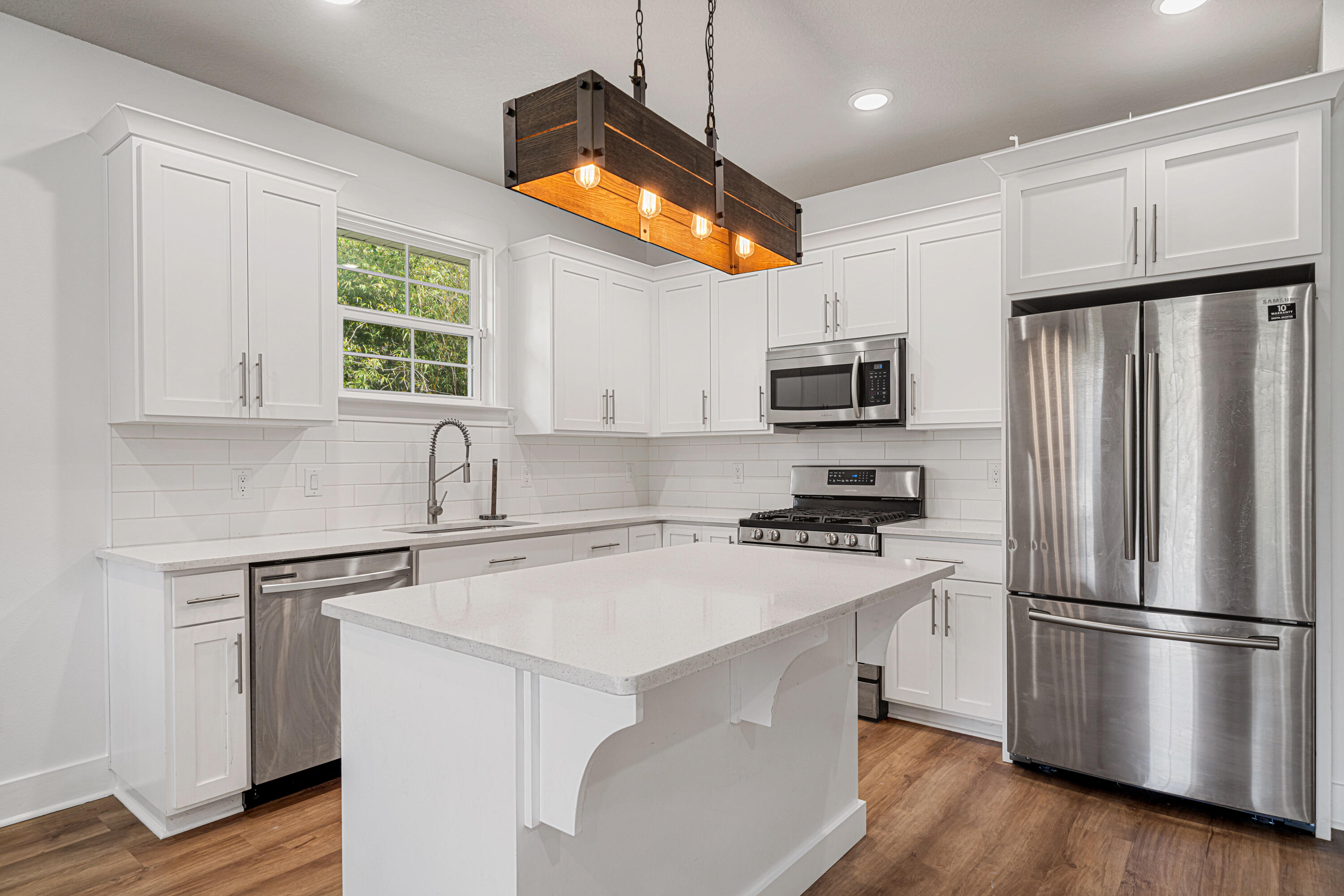 SELLER SAYS - THIS MUST GO! Now priced below comps & ideally located in downtown Pensacola, this modern townhome built in 2020 is just minutes from dining, shopping, hospitals, waterfront attractions & 15min to Pensacola Beach! Updated in 2025 with new paint & luxury vinyl plank flooring - it features 2 large bedrooms WITH additional office/nursery room just off master and 2 bathrooms. With 9 ft ceilings throughout & an open floor plan - the kitchen offers granite, gas range, island, full pantry, and no-slam cabinetry. Washer/Dryer hook-ups in hall with tankless gas water heater. Enjoy exterior side gate access, dual covered patios, exterior storage space, plus a fully fenced yard with sprinkler system. Call today for your private tour!