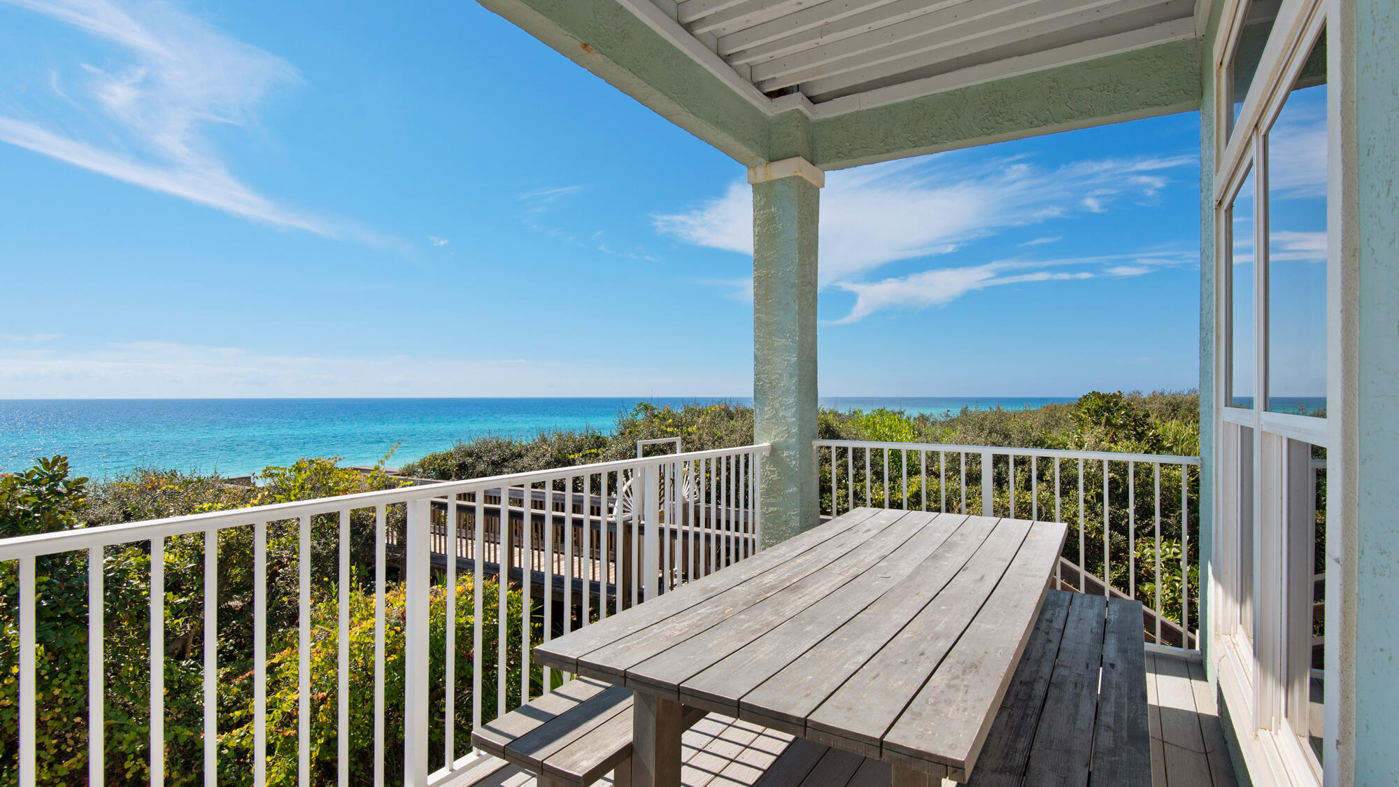Located just steps away from the beach, this condo provides direct access to pristine sands and breathtaking Gulf views. The highlight of this property is the expansive 400 square foot porch that stretches across the Gulf-side, offering truly spectacular views. Take in the sights, sounds, and salty breeze as you relax on the porch and soak up the coastal ambiance. Inside, you'll find a luxurious master bedroom with French doors leading to the porch, allowing you to wake up to the beauty of the ocean.

All new luxury vinyl flooring throughout. The master bathroom boasts a freestanding tub, a large frameless glass shower, and gleaming subway tiles, creating a spa-like retreat. Two front bedrooms offer comfortable accommodations, with one featuring a king bed, a balcony overlooking the pool, and a stylish bathroom with glassed-in shower. The other front bedroom showcases a queen bed and a balcony overlooking the pool. A Jack and Jill bathroom connects this room to the fourth bedroom, the bunk room, capable of sleeping six guests with a full-over-full bunk bed and a twin-over-twin bunk bed.

This unit also offers fantastic amenities for your enjoyment. Take a refreshing dip in the pool located at the front of the condo, or make your way to the private beach only steps away from the property. The design of the home exudes a light and airy beach vibe, reminiscent of the Malibu Surfer style. The well-appointed kitchen is a crowd pleaser, equipped with stainless steel appliances, cooking utensils, and a separate island/bar that provides a beautiful beach view while you prepare meals. Dine indoors at the long trestle table or enjoy al fresco dining on the porch. Additional outdoor seating is available, including a sitting area for sunset gazing

Sleeping Arrangements:
Bedroom 1: King bed, TV. Private bathroom with freestanding tub and shower.
Bedroom 2: Queen bed. Private bathroom.
Bedroom 3: King bed. Jack and Jill bathroom.
Bedroom 4: Twin-over-twin bunk beds. Jack and Jill bathroom.
Bedroom 3 and 4 share a bathroom.