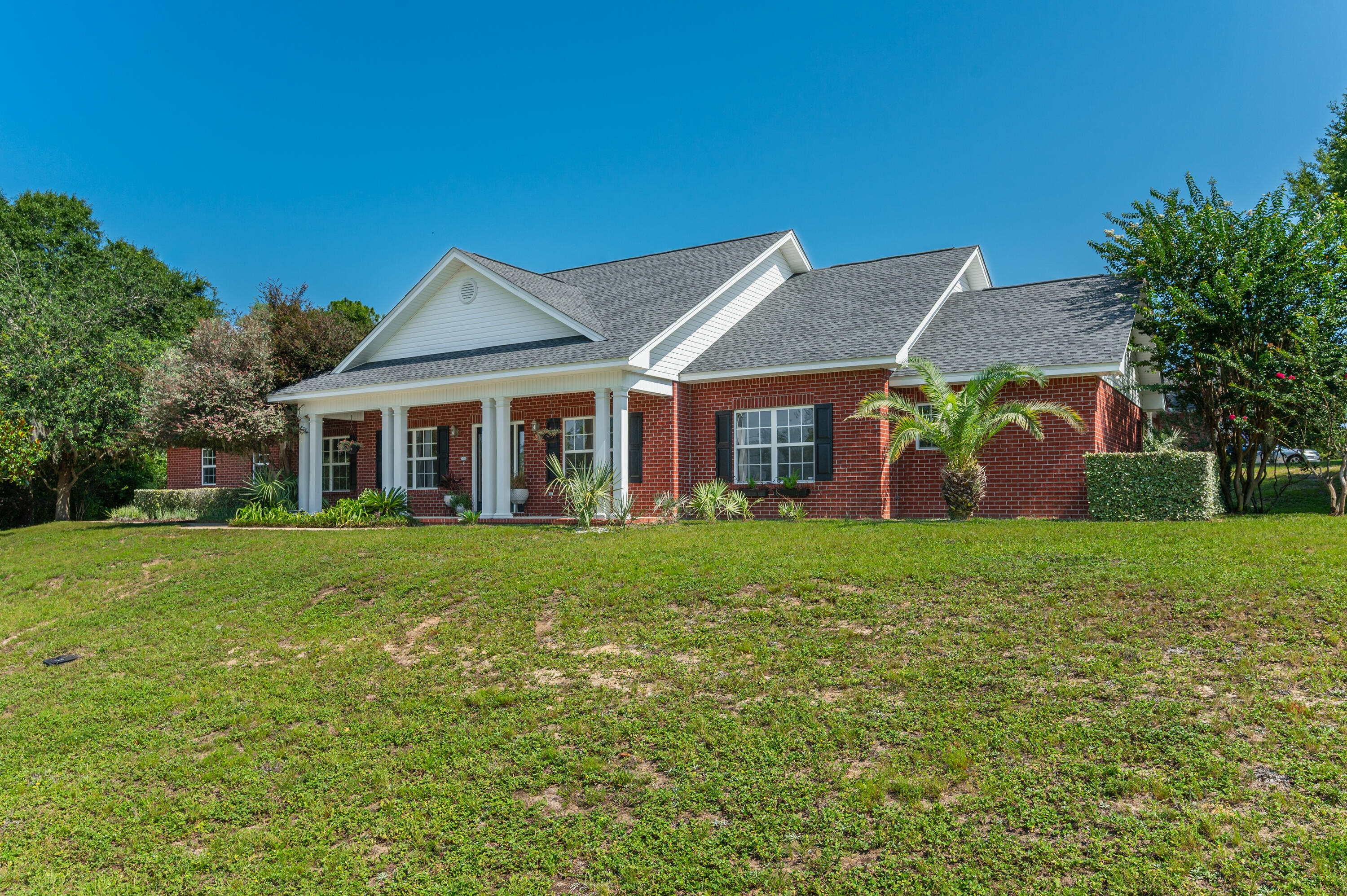 Welcome home to this beautiful classic red brick residence, perfectly situated on a spacious half-acre lot in the desirable Indian Trails community. With a nice curb appeal, a side-entry two-car garage, and inviting covered front and back porches, this home offers the perfect blend of charm, comfort, and functionality. Step inside to discover a freshly painted interior featuring crisp walls and trim, an open-concept floor plan, and a spacious living room complete with custom built-in shelving and cabinetry. The well-appointed kitchen showcases rich wood-stained cabinets, granite countertops, black appliances (including the refrigerator), a center island, and ample space for cooking and entertaining. Enjoy meals in the sunny breakfast area or host special occasions in the formal dining room. Offering five generously sized bedrooms and three full bathrooms, this home provides plenty of room for family and guests. The spacious primary suite features dual vanities, a walk-in closet, a relaxing garden tub, and a separate shower. Outside, the fenced backyard is ready for summer fun with an above-ground swimming pool and plenty of room to relax, entertain, or play. Don't miss the opportunity to make this beautiful Indian Trails home your own--schedule your showing today!