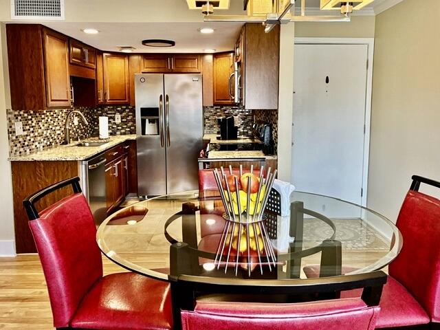 Beautifully remodeled 2-bedroom, 1 bath condo in sought after, gated waterfront community of Finisterra. This move-in ready unit features luxury vinyl plank flooring, 6'' baseboards, crown molding, textured ceilings, recessed lighting, and fresh interior paint. The open-concept design is filled with natural light with a seamless flow from living  to dining spaces, and updated kitchen. The kitchen showcases granite countertops, beautiful cabinetry, glass tile backsplash, and travertine floors. The renovated bathroom features travertine tile, updated vanity and walk-in glass shower. Sliding glass doors lead to a private balcony. Exceptional amenities include community pool, tennis and pickleball courts, kayak storage, BBQ areas, new dock and deck to easily put in your kayak or paddle board, plus beautifully maintained grounds. Ideally situated near Eglin AFB, Hurlburt and Duke Field, shopping, dining, and the white sandy beaches of the Emerald Coast. It's the perfect combination of convenience, and affordable, low maintenance, sophisticated coastal living. Welcome to the Florida Lifestyle!