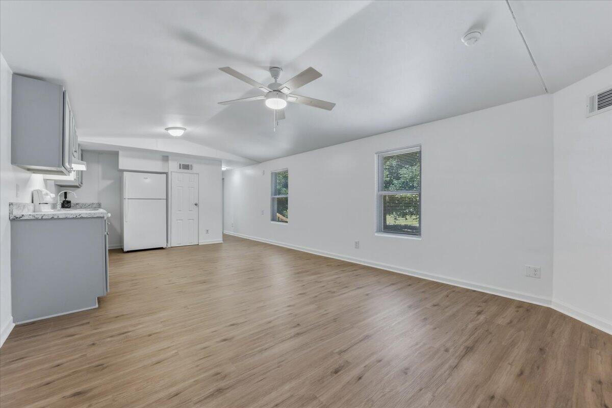 NEW, NEW, NEW and never lived in since the renovation! This beautifully updated 2-bedroom, 2-bathroom home has been completely renovated from top to bottom, offering a fresh, modern feel throughout. Major improvements include a new roof (2024), HVAC system (2024), water heater (2023), and new exterior stairs. Step inside to discover new flooring, fresh neutral paint, and stylish blue/grey accent details on the doors and cabinetry that create a cohesive design. The kitchen features all-new cabinetry and countertops, providing both style and functionality. The split-bedroom floor plan places each bedroom on opposite ends of the home, offering privacy and personal space. Both bathrooms include tub/shower combinations and single vanities, while the primary bathroom also features convenient washer and dryer hookups. Situated on a quarter-acre lot, this property offers a peaceful setting nestled among the trees. Enjoy the freedom of a neighborhood with no HOA while still being conveniently located just 3 miles from historic downtown Milton and only 6 minutes from I-10 for an easy commute. Move-in ready and waiting for its very first occupants since the renovation, don't miss this like-new home!