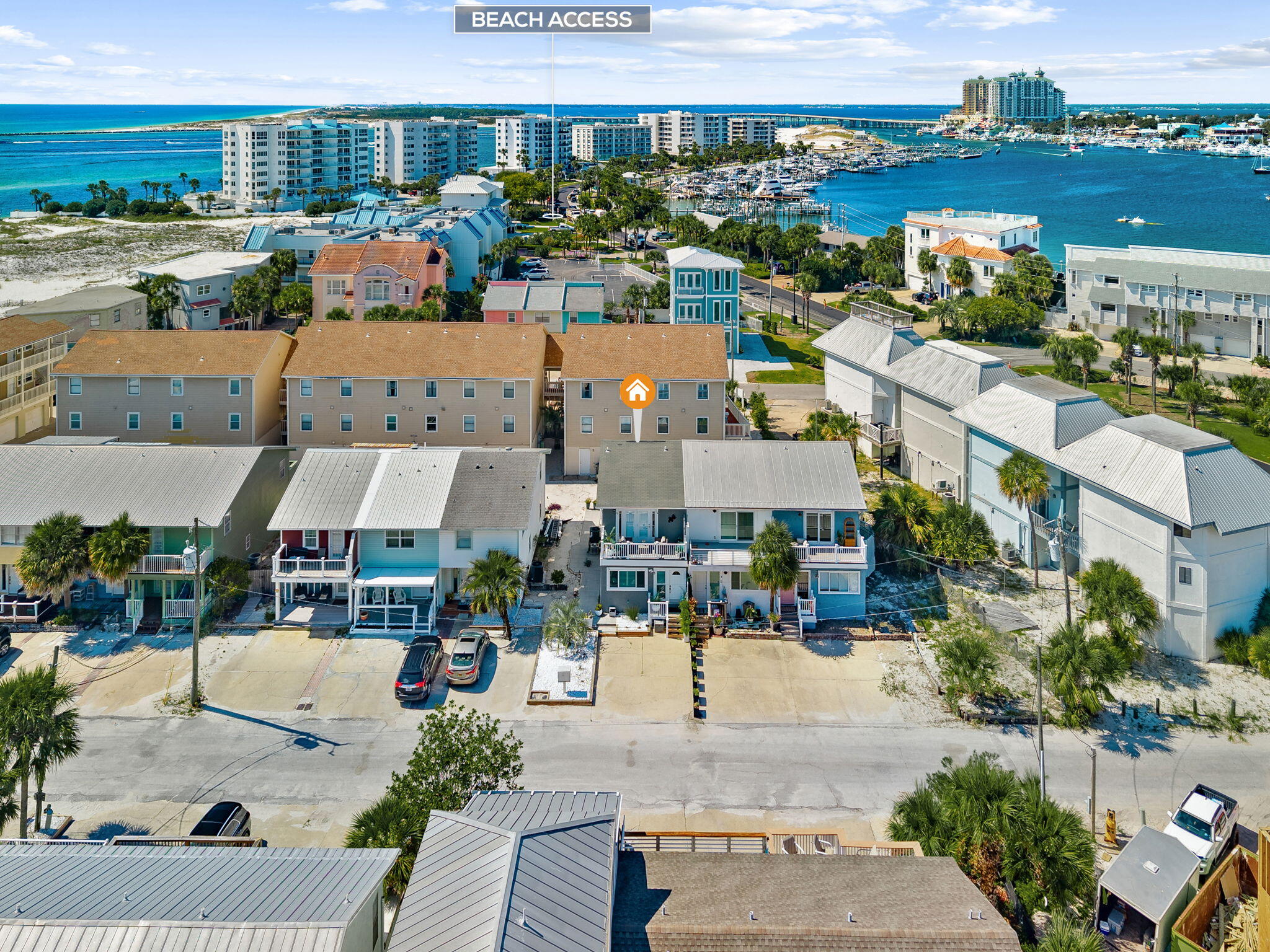 BEAUTIFULLY RENOVATED & JUST MINUTES  FROM THE WATER! This sleek 2BR/2.5BA townhome is located in sought-after Holiday Isle in Destin, surrounded by the crystal-clear waters of Destin Pass and the Gulf of Mexico, with beach access just a short distance away. The open-concept kitchen, dining and living area is located on the second floor with front and rear Trex composite decks, perfect for entertaining, grilling and enjoying the Gulf breeze. Gorgeous distressed wood floors complement the spacious kitchen featuring quartz countertops, glass tile backsplash, abundant cabinetry and upgraded stainless appliances. A butler's pantry/flex/office space with French door & half bath complete this level. Downstairs are 2 spacious bedrooms, each with an updated baths. The primary suite features his-and-her closets, spa-like bath with oversized tiled shower, dual vanities & sliders to a private patio. Upgraded lighting, fixtures and shiplap accents add coastal style throughout. Low HOA fees and a prime location near harbor-side dining, shopping & entertainment add to the appeal. Great for primary residence or Investment-short term rentals are allowed.