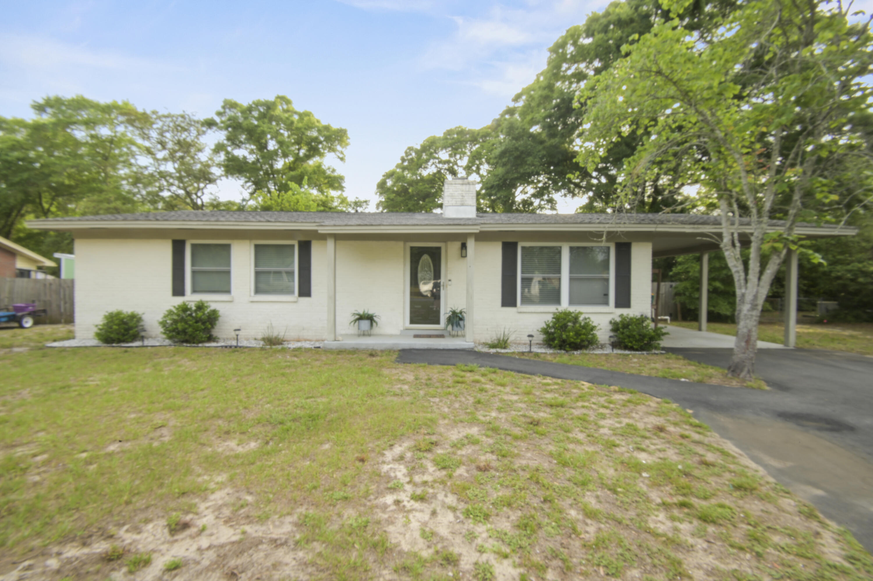 This beautifully updated brick 3-bedroom, 2-bath home in The heart of Fort Walton Beach checks all the boxes. The open floor plan makes the space feel larger than it is, with luxury plank running through all main living areas and carpet in the bedrooms. The kitchen has been tastefully modernized with granite countertops, subway tile backsplash, and stainless steel appliances and modern units.  The sun-filled family room is the heart of the home, anchored by a wood-burning fireplace and opening directly to a large, fenced backyard with a generous patio and pergola -- ideal for weekend cookouts or winding down in the evenings. The master suite features a tiled master shower and updated vanity give the primary bath a clean, finished look. Updates over the past few years include the AC unit, water heater, paint, lighting, and flooring, so the big-ticket items are already handled. The community also features a private boat launch -- a standout perk for anyone who enjoys life on the water. Located in Colony Estates, you're just minutes from schools, shopping, and restaurants, with easy access to Hurlburt Field, Eglin AFB, and the beaches of Okaloosa Island. This one is worth a look -- schedule your tour today!
