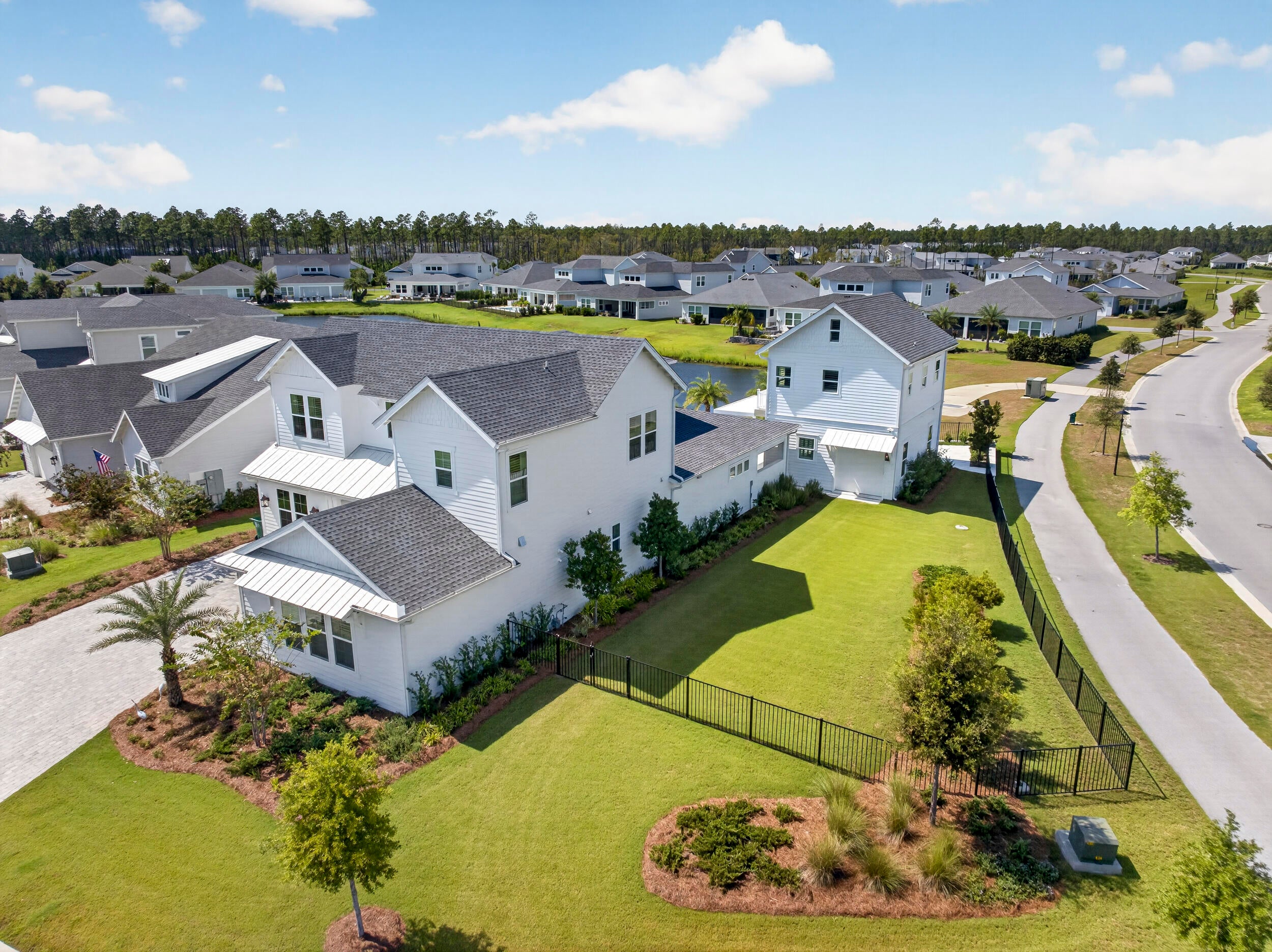 Welcome to 22 Bahia Court, an exceptional multi- generational custom compound located within the gated NatureWalk section of Watersound Origins. Thoughtfully designed for elevated full-time living and effortless entertaining, this one-of-a-kind property pairs a 4,020-square-foot main residence with an additional 800-square-foot carriage suite, all situated on an expansive .34-acre corner homesite with a fenced and gated yard.
The outdoor living spaces are a true extension of the home. A heated and chilled saltwater pool with water features anchors the private courtyard, complemented by a StruXure cabana with motorized louvered roof and LED lighting, oversized natural gas fire pit, outdoor shower, motorized privacy screens and beautiful Hartstone artisan pavers. Professionally designed landscaping and added palms create a private resort-like setting, while the open outlook beyond the rear fence gives the property an uncommon sense of space. 
Inside, no detail was overlooked. Herringbone French oak flooring, Venetian plaster accents, custom recessed lighting and distinctive tabby seashell wall finishes create a sophisticated yet comfortable coastal interior. The living room features a natural gas fireplace with a custom Silestone surround, while the chef's kitchen is equipped with a 36-inch Monogram professional gas range, Café appliances including a 48-inch built-in refrigerator, Silestone waterfall countertops, custom wood range hood, pot filler, beverage refrigerator, under-counter ice maker and dedicated coffee bar.
The primary suite continues the home's spa-like feel with a striking wet room featuring a Kohler Stillness Japanese soaking tub and Moen U smart spa shower. Even the laundry space was thoughtfully designed with a dedicated pet and beach wash station.
One of the home's most memorable spaces is the purpose-built theatre room featuring 9.2.4 Dolby Atmos sound, a 100-inch-plus screen, raised platform with custom recliner seating, walnut wall panels, ultra-plush carpeting, additional sound insulation and a dedicated AV closet. Integrated speakers extend throughout the main level and outdoor living areas for seamless entertaining. 
The separate heated carriage suite provides incredible flexibility for guests, extended family, an office or private quarters. Designed as true living space rather than an afterthought, it includes a bedroom suite, kitchenette, balcony and folding doors opening toward the pool. An additional entertainment kitchen with ice maker, golf cart charging and EV charging further enhance the property's functionality.
Behind the beautiful finishes is an equally impressive collection of systems including high-efficiency Carrier HVAC with HEPA filtration and fresh-air intake, spray-foam attic insulation, Navien natural gas tankless water heating, whole-house water filtration, Moen Flo smart shutoff, Generac whole-home generator, UniFi networking, fiber connectivity, Cat6 wiring, smart lighting, MyQ garage technology and Ring security. 
Located within gated NatureWalk at Watersound Origins, residents enjoy access to community amenities, golf, trails and the greater Watersound lifestyle, with Lake Powell, shopping, dining, healthcare, premium Walton County education, Camp Creek and the Gulf all just minutes away. 22 Bahia Court is a rare opportunity to own a meticulously customized home offering the space, privacy and amenities of a private resort in one of 30A's most desirable communities.