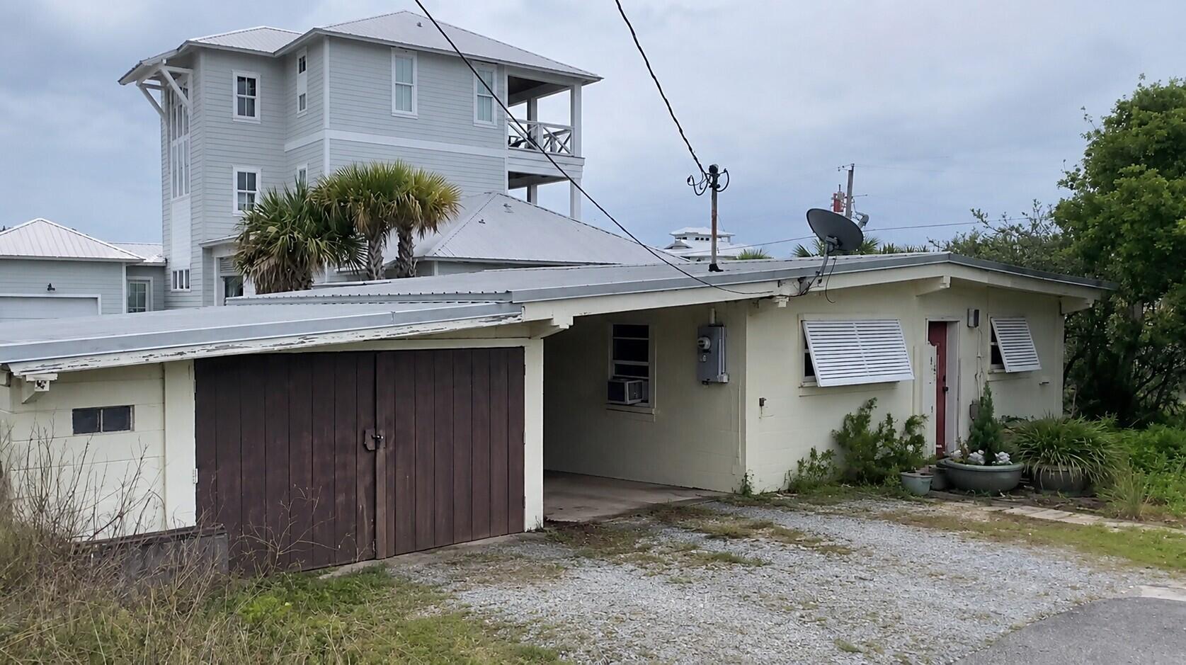 BRING ALL OFFERS! This is liveable, but essentially a teardown. The home is surrounded by multi-million dollar & multi-level homes. This lot/land has gulf views and an oversized lot. Not in a flood plain and 1.5 blocks from 30A. A dream spot for a dream home!
