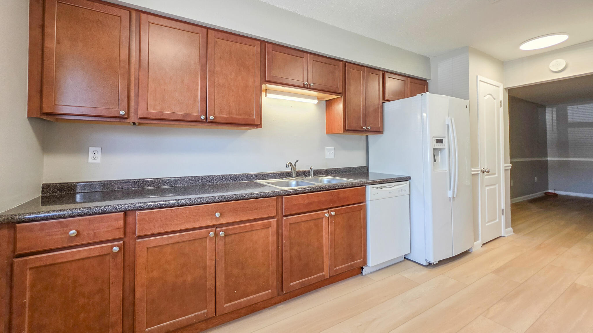 Freshly updated townhome, WITH A BRAND NEW ROOF in 2026. This 3-bedroom 2.5-bathroom features NEW VINYL FLOORING AND A FRESHLY PAINTED INTERIOR. The kitchen blends modern updates with easy, livable layout that features beautiful wooden cabinetry and generously sized countertops, while also having a convenient dual pantry hallway. Flowing directly into the living area, the home offers generous living space, with additional storage space. The second floor layout holds the primary bedroom with exceptional space, featuring the primary bath, perfect for privacy and convenience. The additional bedrooms , generously-sized, featuring a beautifully redone full bathroom, providing fresh, modern finishes. This refreshed townhome offers a fully fenced backyard, for added privacy, and a convenient exterior utility closet for extra storage. The inviting community pool is just feet away, offering the perfect extension of outdoor living.