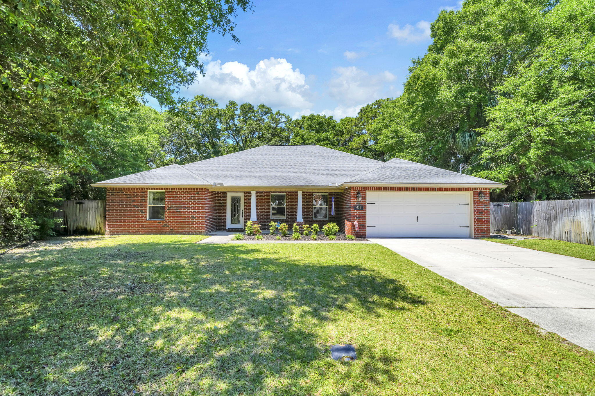 Welcome to 413 Webster St! This 3-bedroom, 2-bathroom home was built in 2014 and offers nearly 2,100 sq ft of living space on 0.37 acres of land. The home features a two-car garage, split floor plan, separate laundry room, and a massive fenced-in backyard with a covered lanai. Entering the home, you'll notice the beautiful tray ceilings and tile flooring in the oversized living room. Flowing into the dining room and kitchen, you'll love the granite counter tops, backsplash, stainless steel appliances, and plenty of storage between the cabinets and the pantry. The primary bedroom offers an en-suite bathroom that includes a walk-in closet, dual vanities, and two separate showers (one of which is a shower/tub combo). The two additional bedrooms share a full bathroom that includes a dual vanity and shower/tub combo. As you make your way to the back yard, you'll enjoy the extended covered patio, additional decking, outdoor shower, and a backyard that offers an abundance of room for entertainment as well as privacy. This property is a fantastic location with easy access to Eglin AFB or the beach. Call for a showing today!