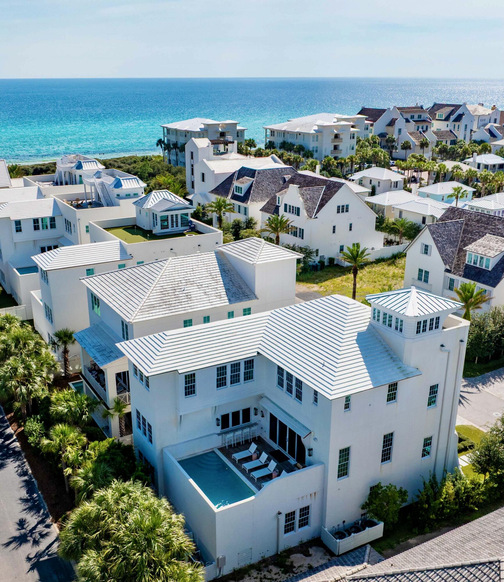 Welcome to Santimo Beach, where this 5,976 square-foot residence is among 20 exclusive properties inside the gated community.  Including dedicated beach access and built by the prestigious Benecki Homes with interiors curated by Melanie Turner this spectacular property has it all. The home's three elevator-accessible floors accommodate five bedrooms, a bunk room, five full bathrooms, and a powder bath. A staircase connects the third level to the tower, which offers panoramic views of the Gulf. Two king-size bedrooms, one with an ensuite bathroom, along with a bunk room, separate a guest bathroom, and a laundry room join an oversized two-car garage with a Tesla charging station on the ground floor. The emphasis on indoor-to-outdoor living is evident once you walk upstairs, where an open-concept living area connects to an elevated deck featuring chaise lounges and a heated pool.  Accordion windows fully retract at the outdoor bar, creating a pass-through between the pool deck and a casual dining area with a wet bar. Designer cabinets conceal a range of gourmet kitchen appliances, including a Liebherr refrigerator, Thermador freezer, and Asko dishwasher. Luxurious marble accents and a custom vent hood highlight the Wolf range. A waterfall countertop serves as a striking centerpiece on the kitchen island, with bar seating that transitions to an additional dining space.
The nearby scullery neatly contains another Asko dishwasher, beverage center and wet bar. The second floor with the powder bath, a media room and a double queen-size ensuite bedroom. An additional living area on the third floor creates a total of three distinct living spaces for owners and their guests to enjoy. The grande primary suite includes a luxurious bath retreat featuring a walk-in shower and soaking tub plus spacious closet.  A separate light-filled room is the perfect spot for an office or yoga studio. An additional king-size ensuite plus the second laundry room complete this level. This residence boasts multiple living areas, a pool deck meticulously designed for entertaining, elegantly appointed bedrooms, and a prime location within one of the most secluded gulf-front enclaves on 30A. Within its vicinity, you can enjoy both grandeur and functionality, conveniently situated just a short distance from the pristine beach. Santimo Beach is a gulf-front community that is surrounded by the vibrant new urbanism communities of Rosemary Beach and Alys Beach. This gated retreat provides its residents with an unparalleled level of privacy amidst the vibrant social scene that permeates the nearby town centers. These town centers offer a diverse array of shops, restaurants, and events, catering to the diverse interests of their residents.