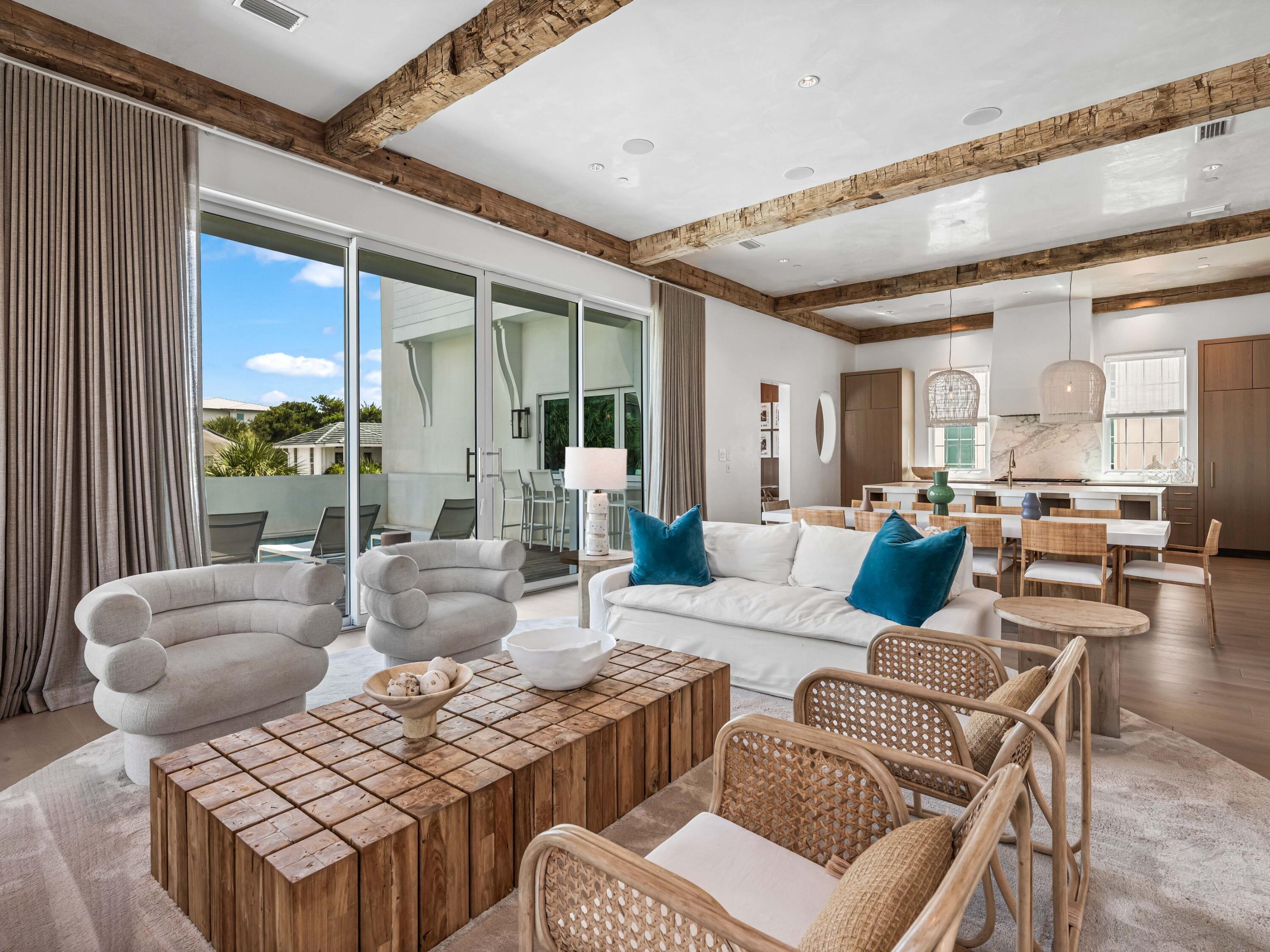 Welcome to Santimo Beach, where this 5,976 square-foot residence is among 20 exclusive properties inside the gated community.  Including dedicated beach access and built by the prestigious Benecki Homes with interiors curated by Melanie Turner this spectacular property has it all. The home's three elevator-accessible floors accommodate five bedrooms, a bunk room, five full bathrooms, and a powder bath. A staircase connects the third level to the tower, which offers panoramic views of the Gulf. Two king-size bedrooms, one with an ensuite bathroom, along with a bunk room, separate a guest bathroom, and a laundry room join an oversized two-car garage with a Tesla charging station on the ground floor. The emphasis on indoor-to-outdoor living is evident once you walk upstairs, where an open-concept living area connects to an elevated deck featuring chaise lounges and a heated pool.  Accordion windows fully retract at the outdoor bar, creating a pass-through between the pool deck and a casual dining area with a wet bar. Designer cabinets conceal a range of gourmet kitchen appliances, including a Liebherr refrigerator, Thermador freezer, and Asko dishwasher. Luxurious marble accents and a custom vent hood highlight the Wolf range. A waterfall countertop serves as a striking centerpiece on the kitchen island, with bar seating that transitions to an additional dining space.
The nearby scullery neatly contains another Asko dishwasher, beverage center and wet bar. The second floor with the powder bath, a media room and a double queen-size ensuite bedroom. An additional living area on the third floor creates a total of three distinct living spaces for owners and their guests to enjoy. The grande primary suite includes a luxurious bath retreat featuring a walk-in shower and soaking tub plus spacious closet.  A separate light-filled room is the perfect spot for an office or yoga studio. An additional king-size ensuite plus the second laundry room complete this level. This residence boasts multiple living areas, a pool deck meticulously designed for entertaining, elegantly appointed bedrooms, and a prime location within one of the most secluded gulf-front enclaves on 30A. Within its vicinity, you can enjoy both grandeur and functionality, conveniently situated just a short distance from the pristine beach. Santimo Beach is a gulf-front community that is surrounded by the vibrant new urbanism communities of Rosemary Beach and Alys Beach. This gated retreat provides its residents with an unparalleled level of privacy amidst the vibrant social scene that permeates the nearby town centers. These town centers offer a diverse array of shops, restaurants, and events, catering to the diverse interests of their residents.