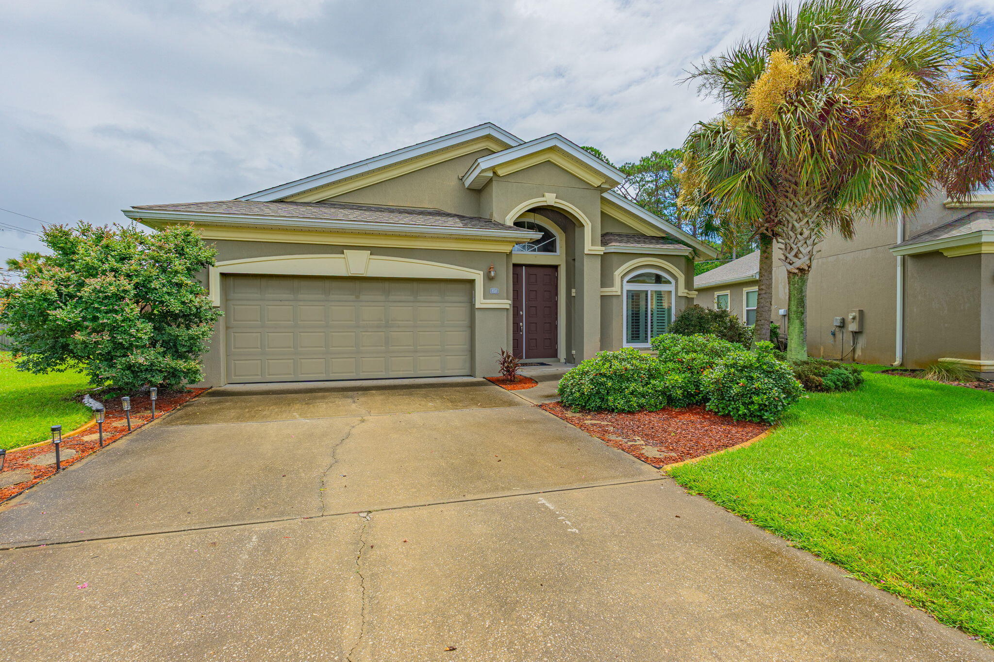 Experience luxury living in this stunning 3-bedroom, open-concept Mediterranean style home located in a Mary Esther, FL neighborhood. Minutes from local military bases, dining, shopping, and the pristine shores of the Emerald Coast, this property delivers both elegance and unbeatable convenience. Immaculate landscaping, a welcoming walkway, and striking double front doors. Soaring tall ceilings, hand-scraped hardwood flooring, custom plantation shutters, and elegant crown molding.  If property is pet-friendly we use petscreening.com to determine the pet rent amount and deposits. Pet rent is not included in the basic rent. Enrollment in the Resident Benefits Package is required.  It includes Renters Insurance, Move-In Concierge to set up utilities for you, regular Air Filter Delivery to your door, Identity Protection, and more. Cost is $50/per month.