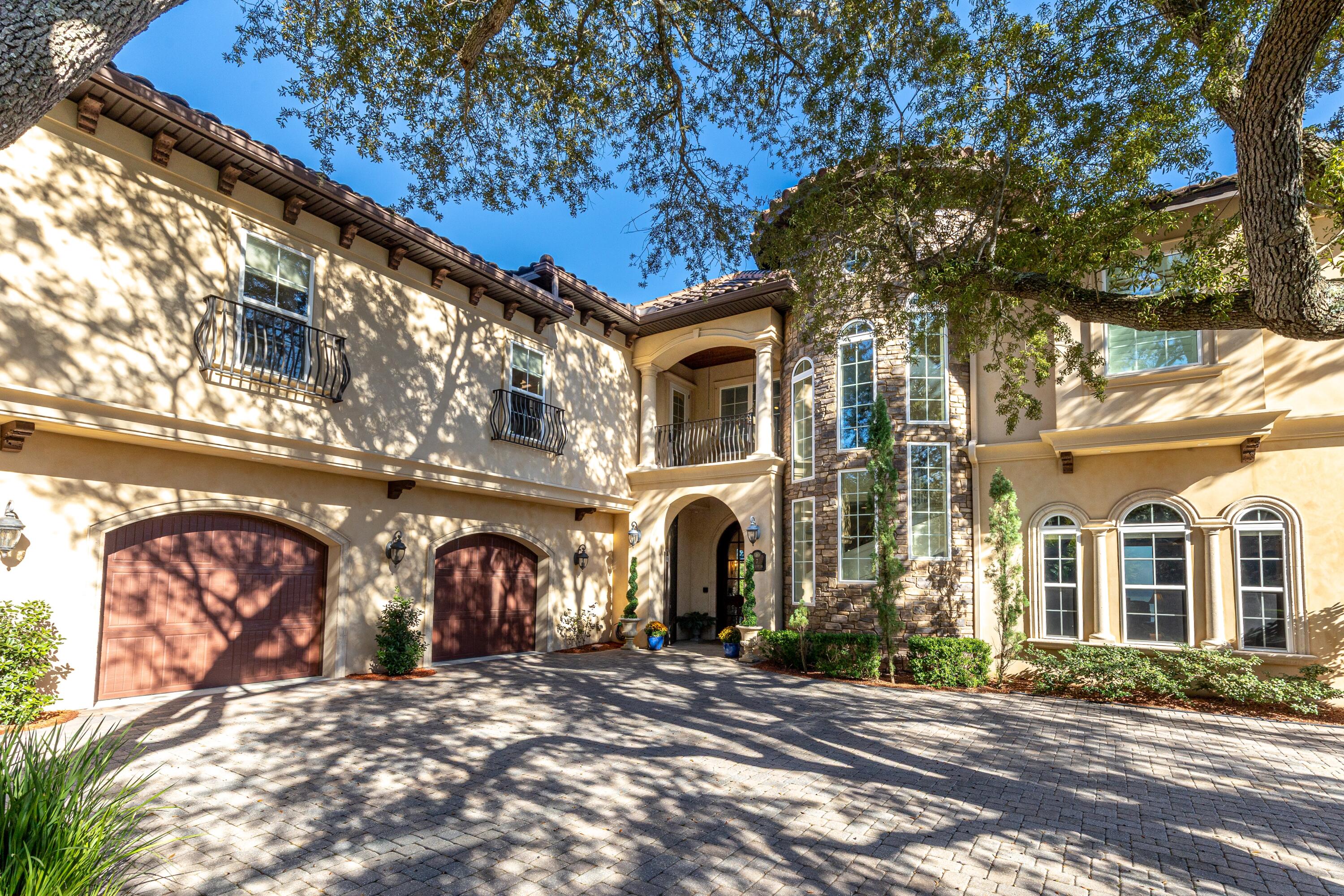 Experience a level of coastal living rarely offered along the Emerald Coast. This Spanish Mediterranean waterfront residence blends architectural elegance, fortress-level engineering, and intentional design for everyday comfort. Set on 102 feet of Choctawhatchee Bay frontage, the home offers more than 9,000 sq. ft. of total space with 7,272 sq. ft. of heated/cooled living area, positioned off of two quiet dead-end streets with only local traffic. Built with 12-inch Logix ICF concrete walls, impact-rated Low-E windows and doors, open-cell foam attic and garage insulation, Hurriquake roofing nails, a concrete barrel tile roof, an upgraded double-thickness vinyl seawall with granite rip rap, Snap Jacket dock piling protection, and a 45kW natural gas whole-house generator, this residence is engineered for strength, stability, and long-term peace of mind. It is also pre-wired for solar and fully framed and prewired for a future elevator, adding future-ready capability to its substantial resilience profile.

After walking up the paved driveway and past lush landscaping with mature trees, the grand entrance begins with bay views through custom 10-foot Spanish Cedar and beveled-glass front doors that lead into a foyer centered around a free-standing engineered travertine staircase crowned by a motorized chandelier set in Pecky Cypress ceiling. Chiseled marble flooring extends throughout  the first floor, guiding you through expansive living and dining areas framed by two full-wall retractable sliding glass doors that open to sweeping bay views. Four gas fireplaces, custom wood cabinetry, granite surfaces throughout, and a dedicated wet bar with ice maker and wine cooler elevate both everyday living and entertaining.

The home's layout reflects thoughtful intentionality. A hidden private staircase leads directly to the study from the master wing, providing private access without disturbing activity elsewhere in the home. The upstairs study/lounge offers flexible space for reading, gaming, work, or relaxation. A full in-law suite includes its own entrance, driveway, kitchenette, bath, and laundry. Additional conveniences include a heated/cooled insulated workshop/garage, four zoned HVAC systems, whole-home A/V and Internet/Data wiring, central vacuum, hands free intercom system, and a stand-up attic for storage.

Outdoor living is exceptional. A 20,000-gallon concrete heated saltwater pool with attached hot tub and custom lighted stone fountain anchors the bayfront backdrop, complemented by two screened lanais (one with a retractable screen), a NatureKast outdoor kitchen with gas grill and hood, and Pecky Cypress ceilings on all covered lanais and balconies. From the pool area, enjoy direct access to the outdoor shower or a dedicated pool bathroom complete with shower and floor drain. The Polaris EOS smart pool/landscape lighting system enables easy control from indoors or remotely.

The reinforced dock offers water, electric, a boat lift, and a jet ski lift allowing you to keep your boat and wave runner on the lift, not in the driveway. From here, you can reach Destin by boat often faster than by car. This location embraces a lifestyle that feels like a postcard: beautiful sunrises and sunsets, dolphins in your backyard, and the ability to walk or take a golf cart to Shalimar Golf Course. On holidays, watch the Niceville, Destin, and Fort Walton fireworks simultaneously over the bay from your fire pit, hot tub, or pool deck. Walk to the end of your dock to pull up blue crabs or catch redfish and trout for dinner. 

Positioned in Flood Zone X, the home does not require flood insurance under current lender guidelines, providing additional ease and confidence for coastal living.

Zoned for the Okaloosa County School District, known for its consistent "A" rating by the State of Florida, this home offers the perfect blend of beauty, strength, practicality, and coastal freedom.

Best of all... NO HOA! Paint your mailbox whatever color you want!