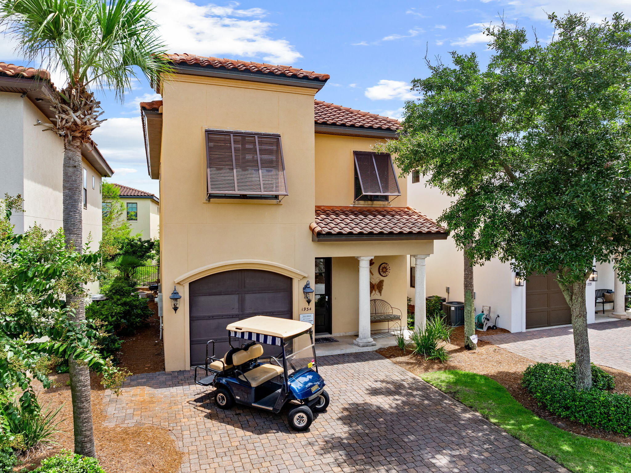 Four bedrooms. Four full bathrooms. Two golf carts. One effortless Sandestin lifestyle. Arrive, park the car, and let the vacation begin. Offered fully furnished and truly turnkey, this spacious Villa Lago residence comfortably sleeps and dines ten, giving family and friends room to gather while providing every guest with a private retreat. Inside, 12-foot ceilings and an open, light-filled living space create an immediate sense of volume. The kitchen is designed for a full house, with granite countertops, an oversized island with seating for five, generous cabinetry, and a walk-in pantry. Polished large-format tile flows throughout the main level, while hardwood flooring extends up the staircase and across the second floor. A bedroom and full bathroom downstairs offer comfort and convenience for guests who prefer to avoid the stairs. Upstairs, all three bedrooms are en suite, including a dedicated bunk room. The private owner's suite feels like a retreat within the retreat, featuring its own sitting room, expansive walk-in closet, and spa-inspired bathroom with a soaking tub, walk-in shower, water closet, dual vanity, and dedicated makeup station. The upstairs laundry is thoughtfully positioned near the majority of the bedrooms. Outside, the covered terrace overlooks a quiet, lily-covered waterway--an unexpected and picturesque setting reminiscent of a tucked-away European village. The home is offered with both four- and six-passenger golf carts, making it easy to explore Sandestin without returning to the car. Walk to Villa Lago's private pool and clubhouse, cast a line in nearby fishing ponds, or cross the street for a day on the golf course. The beach, Village of Baytowne Wharf, Hotel Effie, Spa Lilliana, rooftop cocktails, shopping, dining, and entertainment are all just a golf-cart ride away. Beyond Villa Lago, Sandestin offers 4 championship golf courses, 15 tennis courts, dedicated pickleball courts, miles of walking and biking trails, a marina, year-round festivals, and activities for every generation. Grand Boulevard's upscale shopping, dining, entertainment, and everyday conveniences are less than a mile away. Set within a fully gated resort community with 24-hour security, 1934 Boardwalk Drive offers the space of a private home and the freedom of a complete resort lifestyle--all ready to enjoy from the moment the keys are placed in your hands.