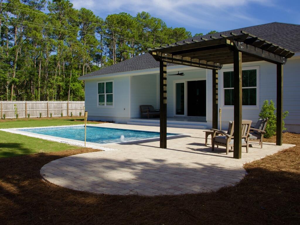 Completed in 2024 and ideally located just north of Hwy 98 with easy access to 30A West, this 4BR/2BA home sits on a spacious ~0.31-acre lot with no rental restrictions. The newly finished backyard offers a private retreat with a pool, paver deck, pergola, and thoughtful landscaping. Inside, the home features 10-foot ceilings, tile flooring, crown molding, and custom trim throughout. A wide three-panel sliding door fills the living area with natural light and opens to the backyard. The primary suite includes a soaking tub, a walk-in shower with a rain head, and a custom closet. Fully fenced with irrigation and a paver driveway. Located ~1.2 miles to Bay Circle Boat Ramp and ~3.5 miles to beach access. PRIVATE POOL | NO HOA | NO RENTAL RESTRICTIONS | FLOOD ZONE X
Luxury, privacy, and coastal living come together in this beautifully crafted 2024 custom home with a newly completed private saltwater pool, ideally located just north of Hwy 98 with convenient access to 30A, the Emerald Coast's sugar-white beaches, Choctawhatchee Bay, dining, shopping, and entertainment. Situated on an expansive ~0.31-acre lot, this property offers a rare combination of space, flexibility, and premium construction in one of Santa Rosa Beach's most desirable locations.
The newly completed private saltwater pool creates a true backyard retreat, complemented by an oversized paver patio perfect for entertaining, relaxing, or enjoying Florida's year-round outdoor lifestyle. The fully fenced backyard provides exceptional privacy, while decorative front fencing enhances curb appeal.
Inside, natural light fills the open-concept floor plan through large impact-rated Low-E windows, highlighting 10-foot ceilings, elegant trim details, and a striking floor-to-ceiling tiled fireplace. A wide three-panel sliding glass door seamlessly connects the living area to the outdoor oasis, creating the indoor-outdoor lifestyle that defines luxury coastal living.
The chef's kitchen is designed for both everyday living and entertaining, featuring an oversized quartz island, abundant cabinetry, premium finishes, and an open layout flowing effortlessly into the breakfast area and an additional flexible dining or gathering space.
The spacious primary suite serves as a private retreat with a freestanding soaking tub, oversized walk-in shower with rain head, custom walk-in closet, and thoughtfully designed storage throughout.
Built in 2024 with premium materials and modern Florida construction standards, this home was designed for durability, energy efficiency, and long-term value. Features include:
- Stem wall foundation
- PGT impact-rated Low-E windows
- Therma-Tru impact-rated fiberglass entry door
- Clopay HDGL wind-rated garage door
- GAF Timberline HDZ architectural roof
- MFM High Heat Smooth Peel & Seal self-adhering underlayment
- Spray foam-insulated attic with batt wall insulation
- Active Sentricon termite protection system
These features contribute to enhanced hurricane protection, lower maintenance, improved energy efficiency, and reduced long-term ownership costs.
Ownership advantages include:
- Private Pool
- No HOA
- No HOA fees
- No rental restrictions
- FEMA Flood Zone X (flood insurance is generally not required by most mortgage lenders)
- Modern 2024 construction built to the current Florida Building Code
For boating enthusiasts, Bay Circle Boat Ramp is approximately 1.2 miles away, offering convenient access to Choctawhatchee Bay, and the spacious lot provides room to accommodate boat storage on-site.
Beach lovers will appreciate being only approximately 3.5 miles from the nearest public beach access, with numerous additional beach access points along Scenic Highway 30A and Scenic Gulf Drive just minutes away.
Everyday conveniences are nearby:
- Walmart - approximately 1.3 miles
- Publix at Grand Boulevard - approximately 2.6 miles
- Silver Sands Premium Outlets - approximately 5.1 miles
Whether you're searching for a full-time residence, luxury vacation home, or investment property, this home offers the flexibility buyers are looking for with no HOA, no rental restrictions, a private saltwater pool, premium hurricane-resistant construction, and a highly desirable Santa Rosa Beach location.
More than just a beautiful home, this is a thoughtfully engineered residence designed to provide lasting quality, exceptional comfort, lower ownership costs, and peace of mind for years to come.