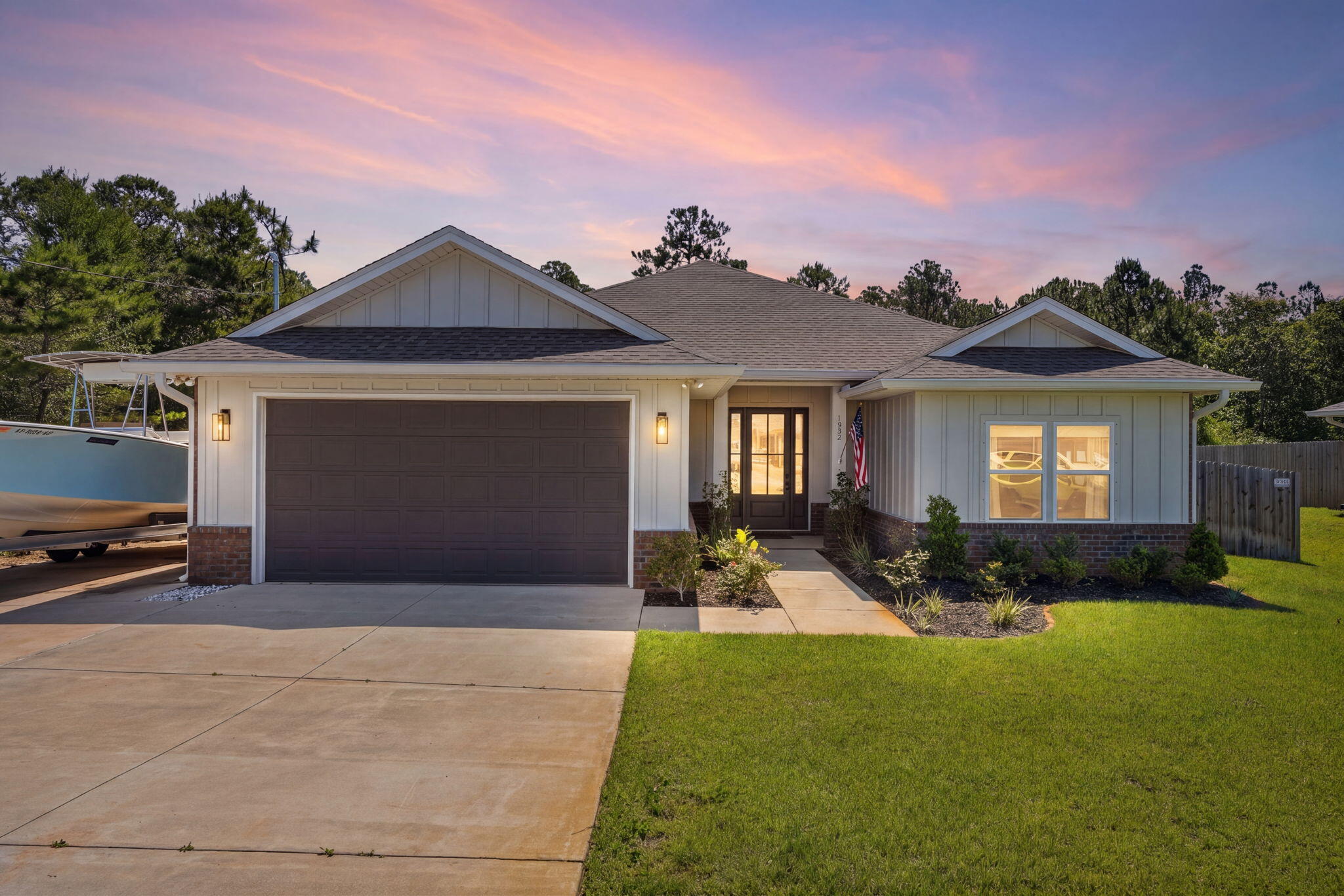 Built in 2022 and move-in ready! With 3 bedrooms, 2.5 baths and over 2200 sq ft home offers the perfect blend of functionality, privacy, and coastal convenience. The open, split floor plan creates an easy flow for both everyday living and entertaining, while the spacious living area opens to a stylish kitchen with abundant cabinetry, upgraded granite countertops, and bar seating. The primary suite features a spa-like bath with a large tiled shower, double vanities, and 2 walk in closets. The two guest bedrooms are connected by a spacious Jack & Jill bathroom, and the convenient half bath is located just off of the living room. The large functional laundry room adds even more practicality to the layout. 

Step outside and enjoy the fully fenced backyard with peaceful woods behind the property, creating a private backdrop with no rear neighbors. The covered back porch and string-lit patio area make the space ideal for relaxing or entertaining. With no HOA, there's plenty of flexibility for boat parking, and the additional concrete pad to the left of the home is perfect for storing your boat or trailer. Plus, Woodlawn Beach boat ramp is only approximately 0.8 miles away, giving you quick access to the water. This home offers the newer construction with the lifestyle conveniences that are hard to find!