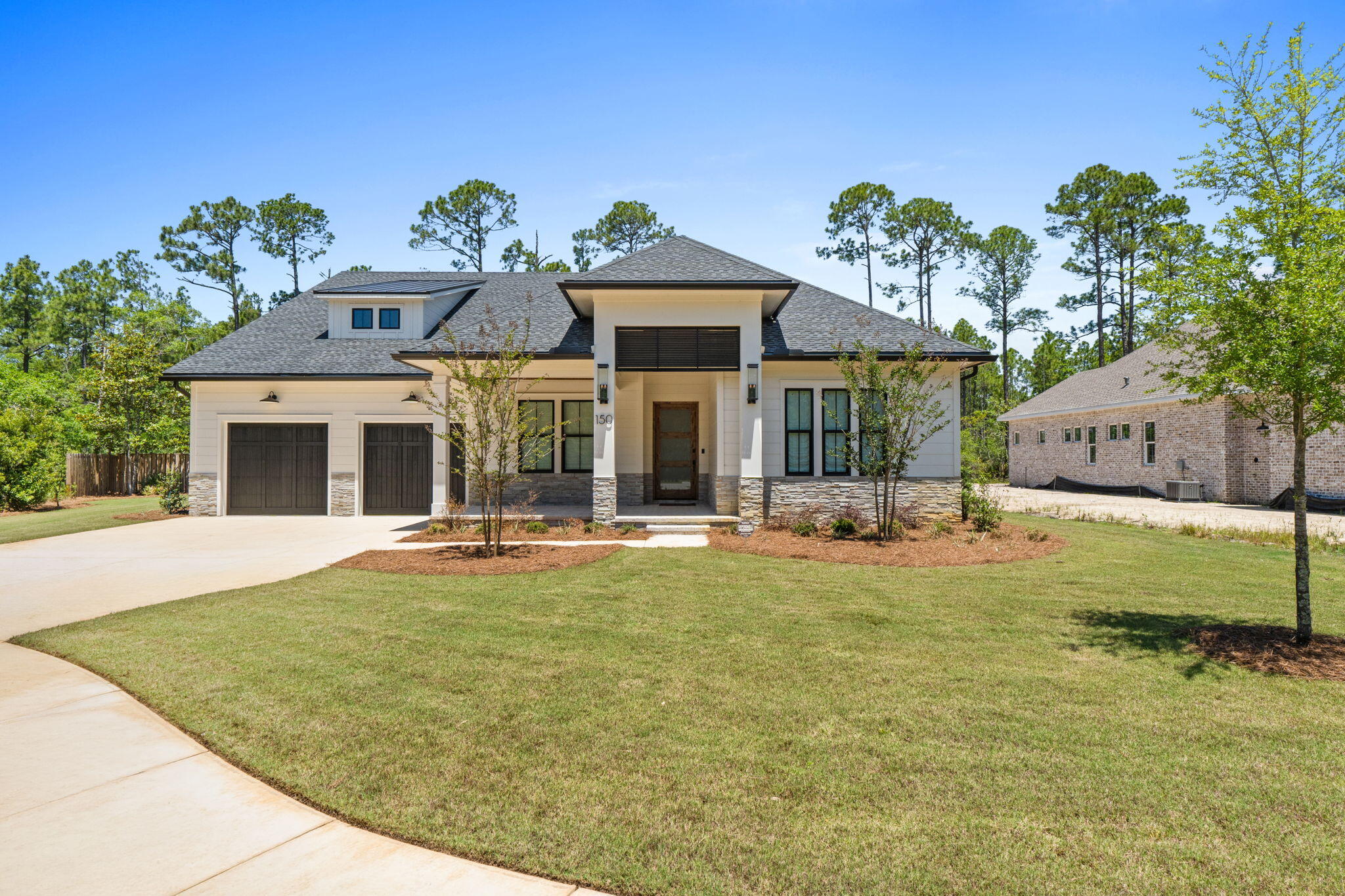 Exquisitely decorated and offered partially furnished, custom 2025 home sits on spacious 1/3-acre private fenced lot on quiet cul-de-sac. Randy Wise dream home backs to 120 acre nature preserve in the highly desirable Steamboat Landing at Hammock Bay. Offering 10ft ceilings, 8ft doors, 2975 SF (and 4745 total square footage), this lightly occupied residence has an abundance of premium upgrades (attached) with warranties still in effect. Step inside the striking 42'' custom wood & glass front door with wireless keypad/doorbell. Engineered hardwoods, custom wood shades and curated lighting fixtures throughout. The gourmet kitchen boasts a Wolf range, modern hood, microwave, oversized refrigerator/freezer, walk-in pantry with ice maker and beverage cooler, and a beautiful Kohler white apron sink. The oversized primary suite features shiplap accent walls, pendant lighting, a custom closet with laundry access, and an oversized primary bath with his-and-her vanities and a large zero-entry shower with multiple shower heads. All showers in the home are zero-entry. Additional highlights include a large family room with tiled fireplace, Sonos sound system, upgraded tile in all bathrooms, Rinnai tankless water heater, and WiFi-enabled security system and oversized garage and door. Outdoor living is exceptional: A large screened porch with shellstone tile & stacked stone gas fireplace opens to an outdoor kitchen complete with grill, hood, and sink. Enjoy evenings lounging in the outdoor living room and eating al fresco with beautiful Florida breezes. The oversized 2-car garage offers room for a golf cart and currently stores a 21ft boat with outboard motor. Additional features include epoxy-coated garage floor, keypad entry for garage doors with motion sensor lighting, pre-wired pool panel, pre-wired for generator, storage loft above garage, and a well for irrigation with water filtration system for iron removal. New washer and dryer are negotiable.

This home is a short walk to the Bayfront Clubhouse and 500' pier, and within ten minutes of two other amenity centers offering four swimming pools, fitness centers, court sports, brewery, Windmills Town Center, General Store and walking trails, all offering the perfect blend of luxury, privacy, and coastal Florida living in Steamboat Landing at Hammock Bay! Buyer to verify all information and dimensions important to them.