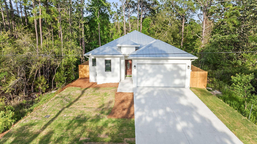 Looking for a brand-new home in the highly desirable Santa Rosa Beach area? Whether you're searching for a primary residence or a great investment property, this home offers the freedom of NO HOA and no restrictions.

Built in 2025, this home offers 1,880 square feet of heated and cooled living space, with a total building size of 2,435 square feet. It includes 4 bedrooms and 2.5 bathrooms and features a modern coastal design with an open-concept layout and high-quality finishes.

This home is built on a solid concrete slab foundation, providing stability and durability. It features 10-foot ceilings, quartz countertops, hardwood floors, stainless steel appliances, and abundant of natural light. The garage features a protective epoxy-coated floor, offering a long-lasting, low-maintenance surface, and provides ample space for a golf cart, equipment, or additional storage.

The fully fenced backyard provides privacy and a safe space for you and your beloved pets.

This home is a dream for outdoor enthusiasts, with plenty of activities nearby, including golf courses, hiking trails, and beautiful state parks. The Cessna Landing Boat Launch Park is less than half a mile away, and you're just minutes from multiple beach access points along 30A, perfect for enjoying the sugary beaches of the Emerald Coast.

Conveniently located near top-rated hospitals and medical centers, as well as fine dining, grocery stores, and shopping centers, everything you need is just a short distance away.

This home is completely move-in ready. Whether you're looking for beach living, rental income, or both, the choice is yours.
Call today to schedule your showing!