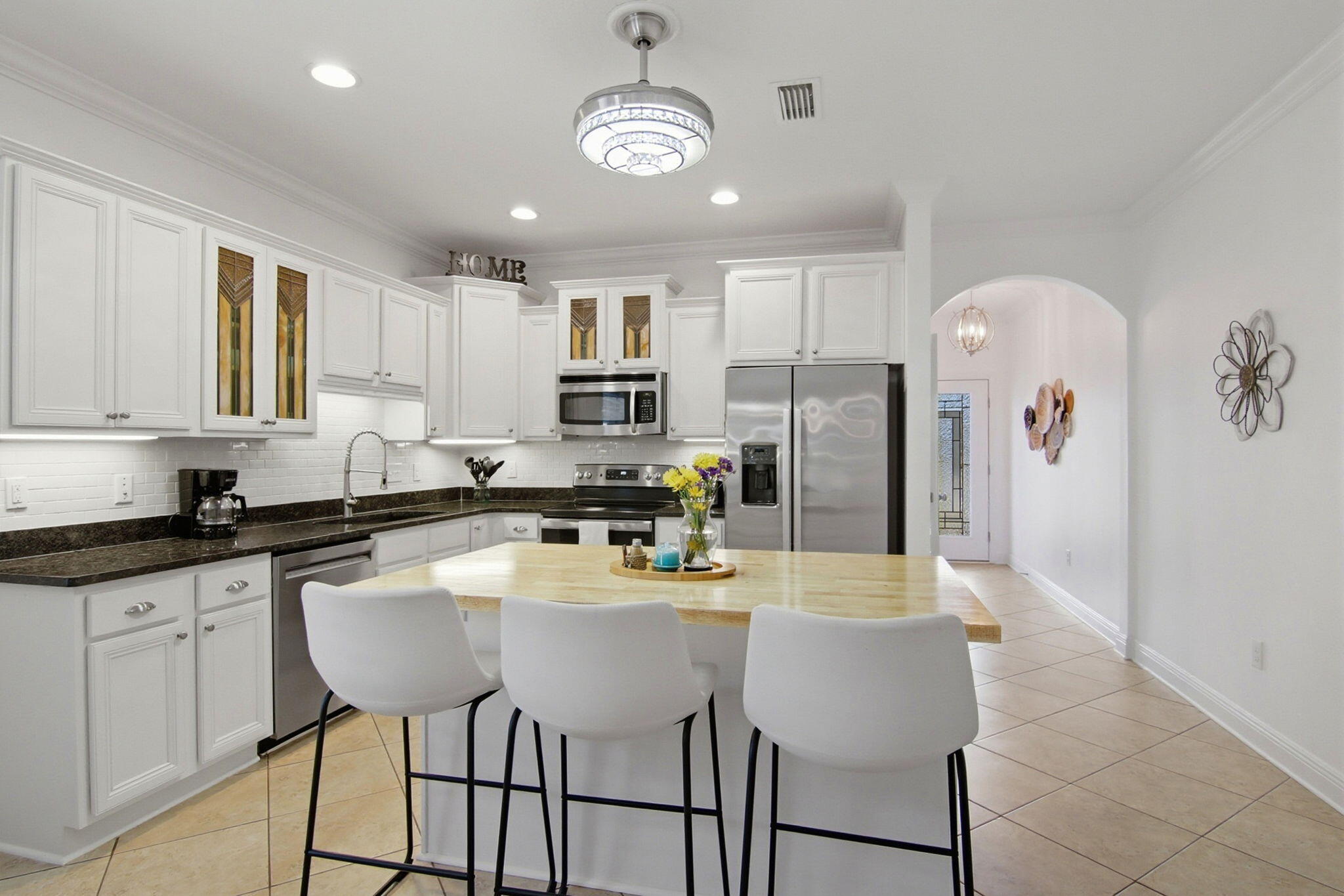 A 'jewel' in Hammock Bay, ready to move in to and enjoy. Meticulously maintained and upgraded with attractive features to enhance your living experience. Lovely kitchen with added drawers, enlarged island, single basin sink, and a full use butcher block countertop. Two convenient pantry closets for food and supplies. Newer kitchen appliances, tiled backsplash, recently painted interior and tiled floor simplify maintenance; allowing for more time to enjoy the large fenced backyard, 500+ sq ft patio, and outdoor living. Established landscaping, full lawn sprinklers, inviting spaces, and room for backyard games/BBQ/activities. Adjoining greenbelt privacy.  Other highlights include: ceiling fans (6), 8' x 15' outdoor storage shed (w/ electricity), gas hot water heater, induction stove top, programable thermostat, solar powered attic fan, newly painted interior and exterior, Ninja Epoxy flooring, plumbed garage sink, added cabinet storage, gutters/downspouts for optimal drainage, and insulated garage door. Dedicated rf/freezer outlet, attic storage, hot water recirculation, ring door bell, and wired for ADT security.    This home is ready to meet the needs of your best Florida lifestyle!