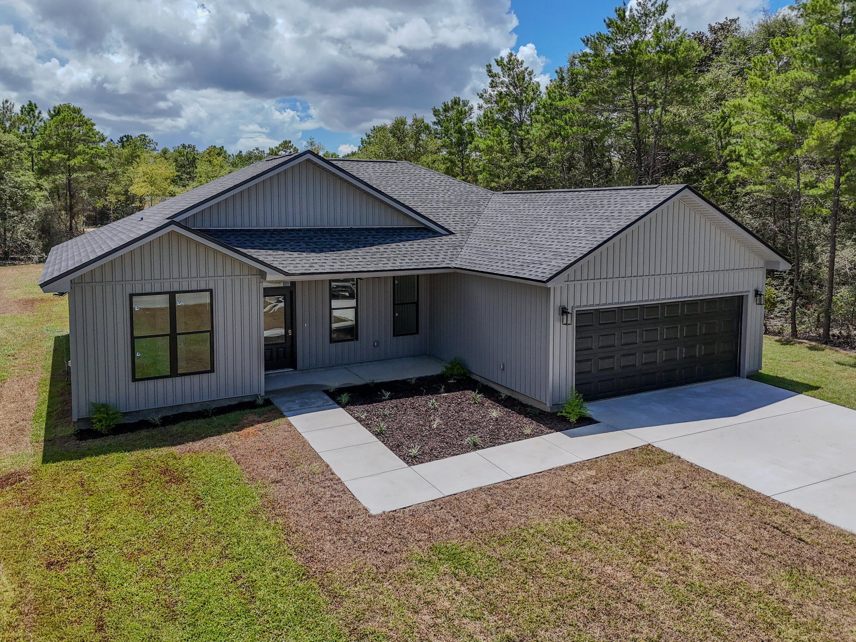 Beautifully crafted new construction by Darby Homes combines quality craftsmanship with modern design..  Step inside to an inviting open-concept floor plan featuring luxury vinyl plan flooring, elegant decorative lighting and gorgeous quartz countertops throughout.  The kitchen is designed to impress with all-wood shaker cabinetry, oversized island perfect for entertaining and a spacious walk-in pantry.  The private primary suite offers a relaxing retreat with custom wood shelving in closet for exceptional organization.  The luxurious ensuite bath includes double vanities and a custom tiled shower.  Built for comfort and efficiency, this home features Low-E coated vinyl windows and open-cell spray foam insulation to help maximize entry savings year-round. The oversized two-car garage includes additional storage providing plenty of space for seasonal decor and extra belongings. Outside, you'll enjoy a fully sodded front and back yard creating beautiful curb appeal and outdoor space.  From its thoughtful details to its upscale finishes, this custom build offers the perfect combination of style, functionality and lasting value.  Don't miss your opportunity to make it yours.