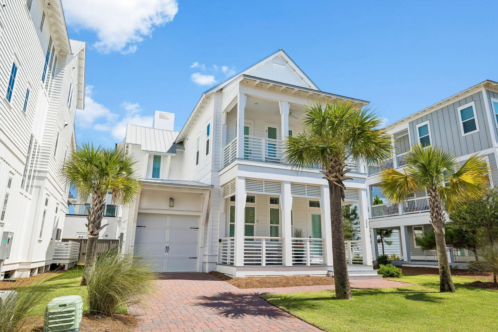 Welcome to 200 Siasconset Lane, an exceptional coastal retreat gracefully positioned at the end of a private cul-de-sac in Prominence, where sweeping Gulf views and refined architecture create an unforgettable first impression. Never rented and meticulously maintained, this residence presents in pristine condition, offering the feel and quality of a brand new luxury home.

A brick-paved driveway welcomes you to the attached garage, while expansive covered porches on both levels and a private screened porch off the main level primary suite invite seamless indoor-outdoor living. Whether enjoying sunrise coffee, sunset cocktails, or the gentle Gulf breeze, every outdoor space has been thoughtfully designed for relaxation and entertaining.

Inside, timeless coastal elegance meets sophisticated design. Rich LVP flooring, soaring 12-foot tongue-and-groove ceilings with painted beams, and walls of windows bathe the home in natural light while creating an airy, inviting ambiance. Two luxurious primary suites adorned with custom shiplap detailing provide exceptional comfort and privacy. Fully furnished with exception of owner's closet contents (both master closets and under stair closet), shell art on 2nd floor guest bedroom, tools, ladders and blower located in garage. At the heart of the home, the chef's kitchen is both beautiful and functional, featuring quartz countertops, a pot filler above the cooktop, premium stainless steel appliances, a spacious pantry, and an oversized island that naturally becomes the gathering place for family and guests. Every finish has been thoughtfully selected to deliver understated luxury and effortless coastal living.