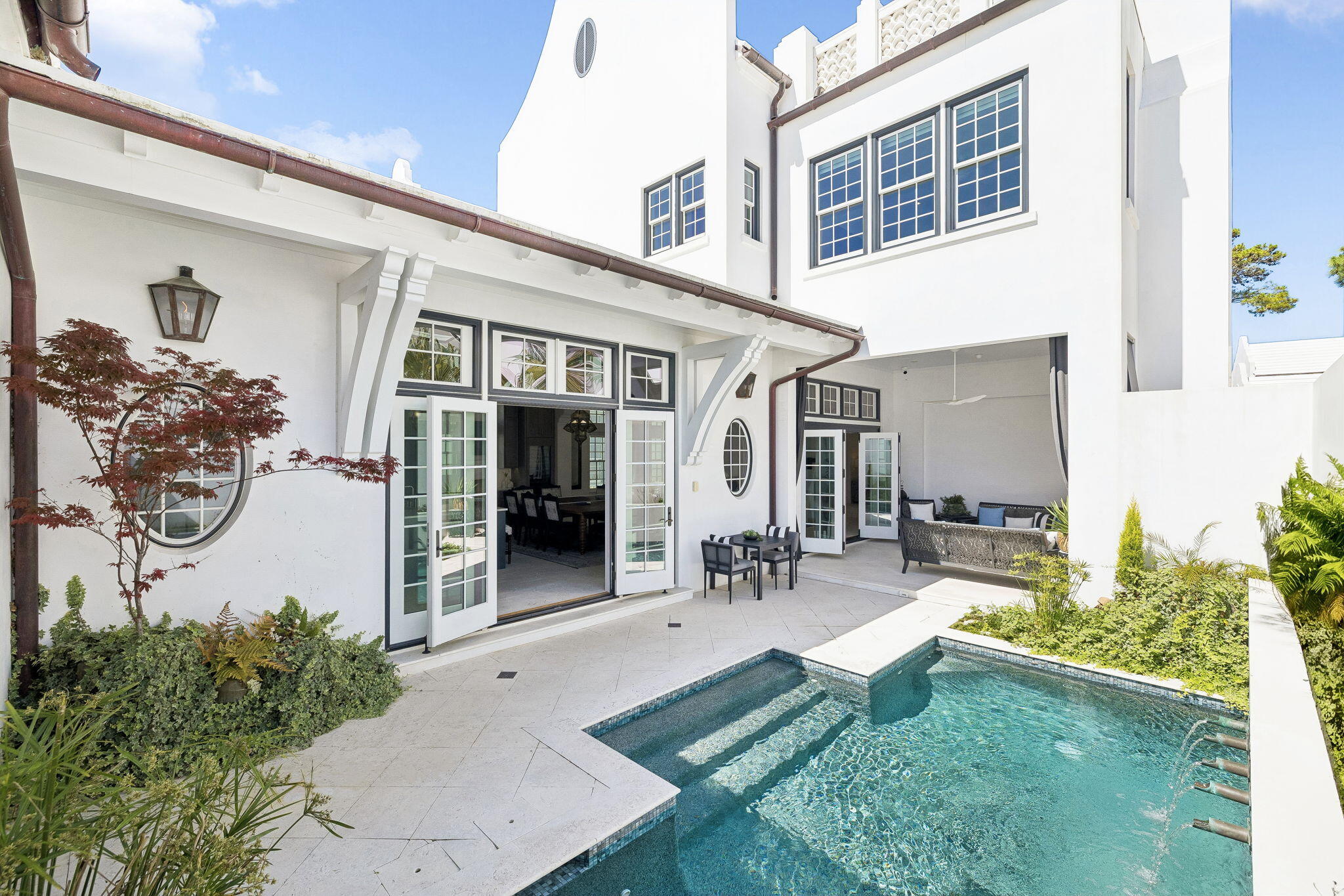 Thoughtfully positioned along the meandering path of Turtle Bale Park North, this exceptional four-bedroom, seven-bathroom residence offers nearly 3,900 square feet of beautifully designed living space and captures the essence of refined coastal living in Alys Beach. From the moment you enter the stately foyer, the home opens into expansive, light-filled interiors where open-concept living seamlessly blends comfort, elegance, and effortless entertaining.
The chef's kitchen is both stunning and functional, appointed with premium Miele appliances, abundant custom cabinetry, and a thoughtfully designed scullery that provides additional prep space, storage, and organization. Throughout the home, an abundance of storage ensures practicality without compromising design.
A junior primary suite on the main level offers privacy and flexibility for guests or multi-generational living. Upstairs, additional guest suites provide luxurious accommodations, while a spacious upper terrace delivers sweeping panoramic views and one of the most breathtaking sunset vantage points in Alys Beach.
Designed to blur the line between indoor and outdoor living, the private courtyard features a sparkling pool, outdoor seating, grilling area, and a cozy fireplace. Expansive nano doors fully open the living space to the courtyard, creating an incredible setting for entertaining and relaxation. Enhancing the experience further are surround sound, full home automation, and an aesthetic that adds warmth and character throughout.
Additional highlights include an architectural staircase that anchors the home's grand design, an oversized two-car garage, and elegant finishes throughout. Offered partially furnished, this extraordinary residence embodies luxury coastal living at its finest and truly checks every box for the discerning Alys Beach buyer.
Alys Beach offers a lively town center with curated dining and shopping options that create a true resort-style atmosphere.  The community is designed by thoughtful green spaces as well as the renowned Alys Beach Homeowner Amenities.