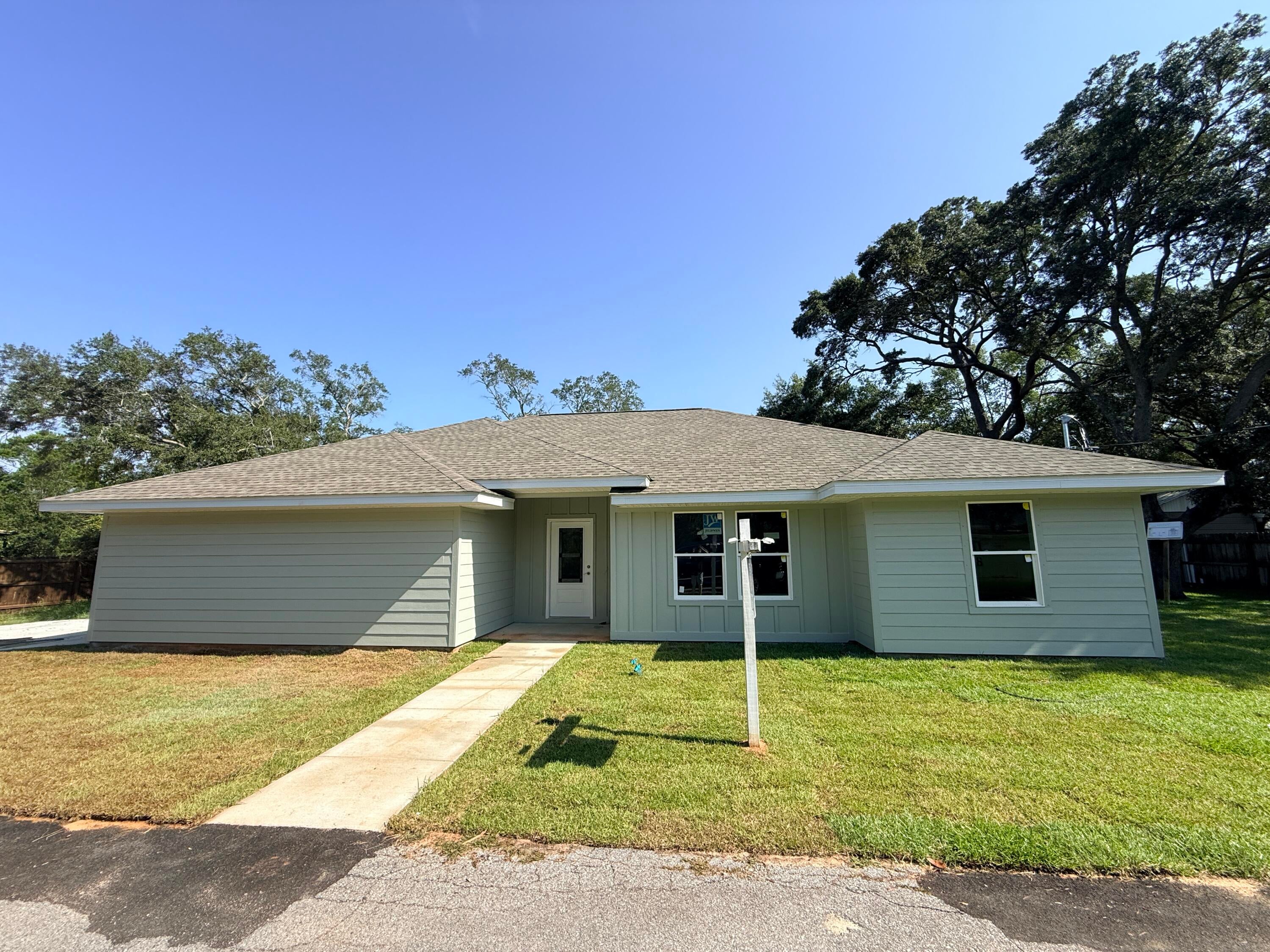 BRAND NEW, MOVE-IN READY, AND NO HOA! Welcome to 4728 Bay Breeze Drive, where modern new construction meets the relaxed Gulf Breeze lifestyle. This beautifully finished home offers 3 bedrooms PLUS a versatile bonus room, 2 full bathrooms, 1,726 square feet, and an attached side-entry 2-car garage. Step inside to an open, light-filled floor plan featuring vaulted ceilings, durable LVP flooring, a spacious kitchen with quartz countertops, large center island, white cabinetry, stainless appliances, and plenty of room for entertaining. The flexible bonus room is perfect for a home office, playroom, guest room, or additional bedroom space.

The primary suite features a beautifully tiled walk-in shower with frameless glass and modern finishes. Outside is where this property really separates itself from typical new construction. Step out onto the large covered back patio, perfect for relaxing, grilling, or entertaining while overlooking the large, park-like yard shaded by beautiful mature oak trees. The side-entry 2-car garage adds to the home's attractive curb appeal while providing plenty of parking and storage. With approximately a quarter-acre lot and NO HOA, you'll have room to enjoy your property without the restrictions and fees of an association. Conveniently located in Gulf Breeze with easy access to shopping, dining, schools, and the beautiful Gulf Coast beaches.  If you've been looking for the low-maintenance benefits of new construction without sacrificing yard space, mature trees, covered outdoor living, or flexibility, this is the one. Schedule your showing today!