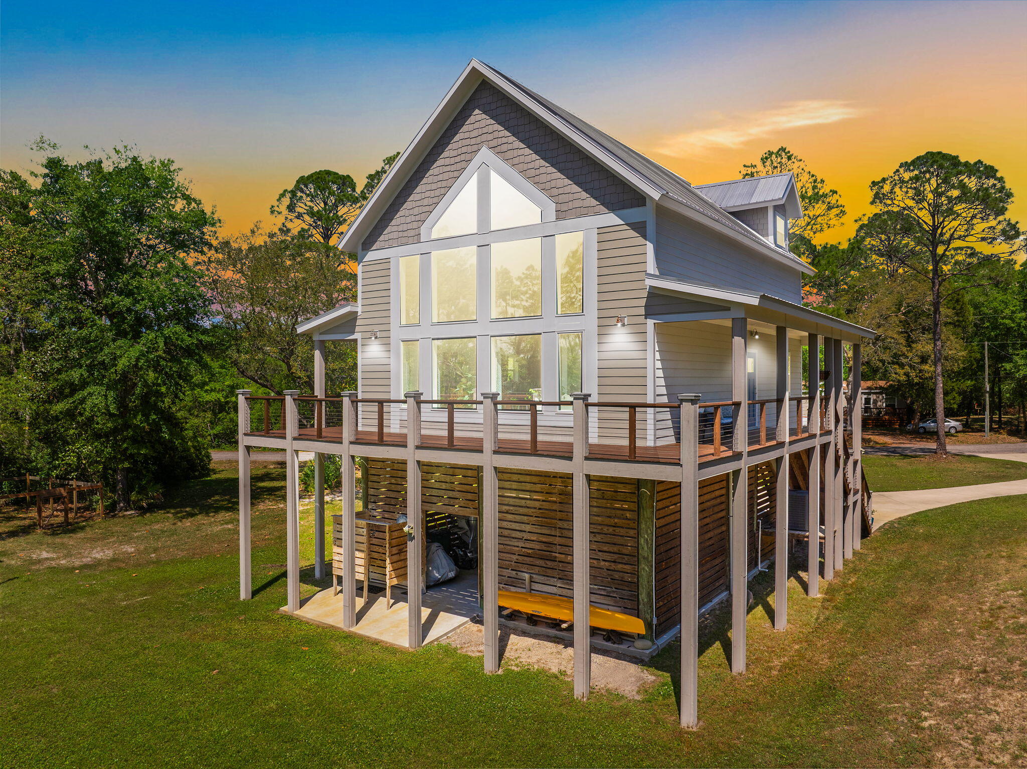 This Craftsman-style home sits on nearly 2 acres with 200 feet of waterfront along a quiet bay! (Boating dock is in place) Located 20 minutes from Pier Park & the emerald waters of Panama City Beach Access, and 10 minutes from ECP International Airport.
 
The 2-bedroom, 2-bathroom house has an open floor plan, & a wraparound deck. Hardwood floors throughout. A Brand new HVAC system one year ago. The living room features 20-foot high ceilings with exposed wood beams and a full wall of windows providing expansive views of the water & Wildlife.. The kitchen is equipped with stainless steel appliances, granite countertops, and a generous breakfast bar. The split bed floor plan includes a downstairs bedroom,/bathroom and a laundry area. Upstairs, is a Lg. bedroom/bathroom overlooking the view