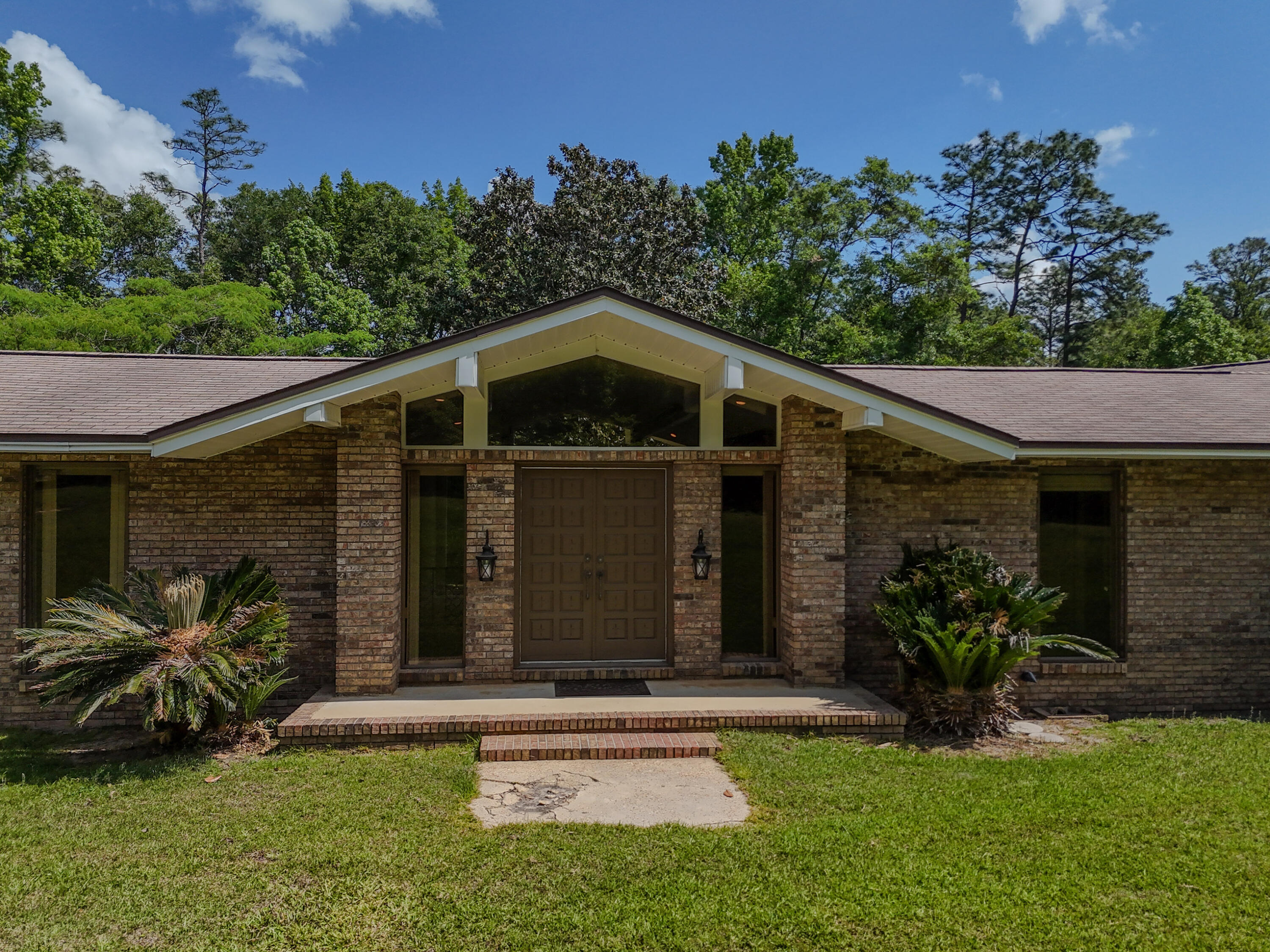 Tucked away on a generous 17.5-acre parcel, this charming 2,899 SF, 4-bedroom, 2.5-bath home.Step inside to discover a classic sunken living room, where oversized windows fill the space with natural light. Each bedroom offers ample space, while the 2.5 baths ensure convenience for both residents and guests.Enjoy the peaceful setting and being within walking distance to the scenic beauty of Falling Waters State Park-perfect for outdoor enthusiasts. Ideally located less than 10 minutes from Chipley Walmart, a variety of shopping options, and easy access to Interstate 10, this home offers both seclusion and convenience. Plus, you're less than an hour from the World's Most Beautiful Beaches in Panama City Beach, including the popular Pier Park shopping and entertainment district.