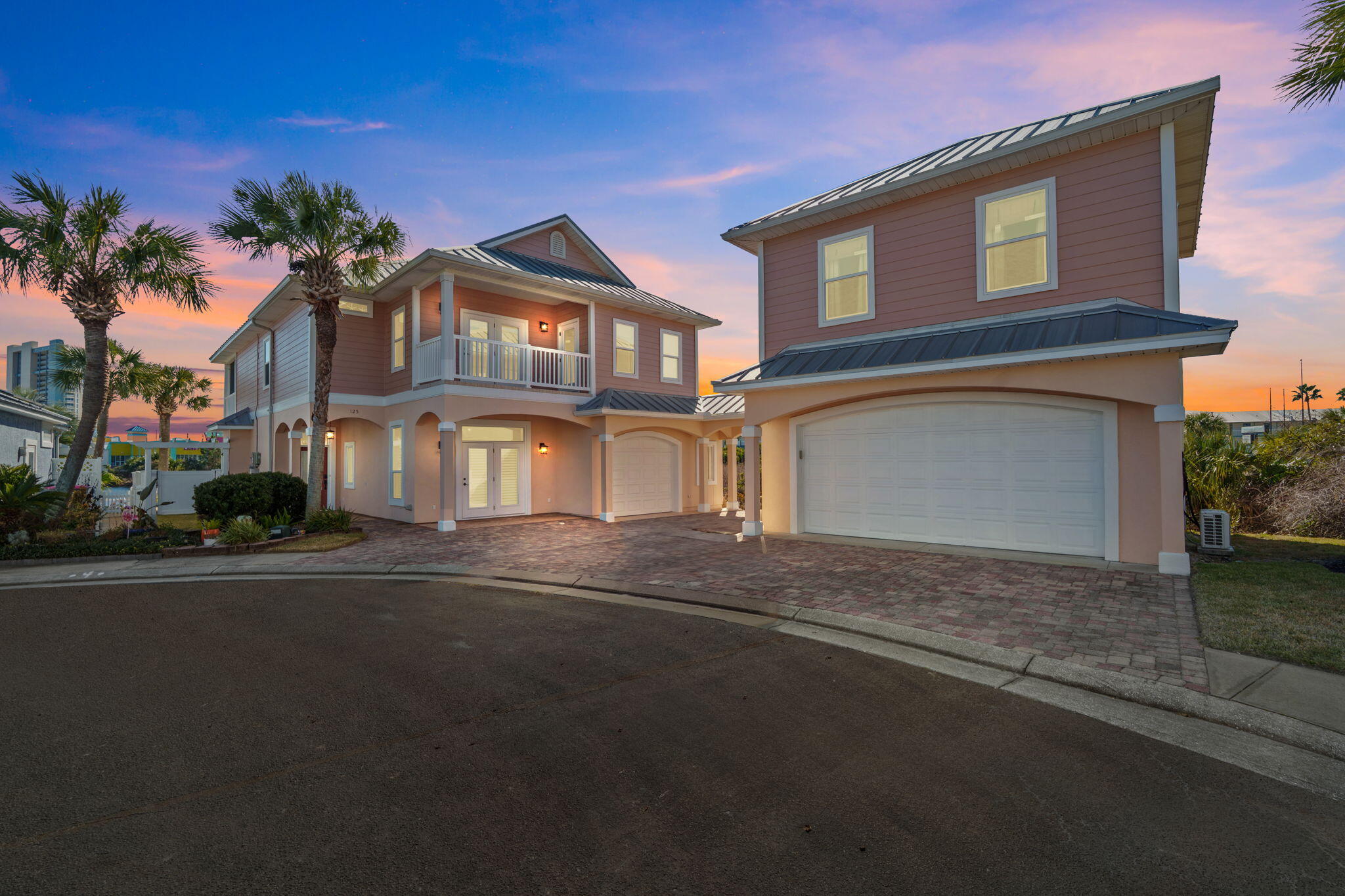 Tucked in the sought after west end Lakes at Summer Breeze, this custom home with an attached carriage house is a rare find. Enjoy lake and Gulf views, sunset balconies, and a short walk to Beach Access 66. The 2,888 SF main home offers 4 bedrooms, 3 baths, high ceilings, walls of windows, plantation shutters, tile and wood floors, a gas fireplace, and an updated kitchen with custom cabinetry and gas stove. A first floor suite with private entrance is ideal for guests. Upstairs, the oversized primary suite features a sitting area, spa bath, and screened balcony overlooking the lake. Two more bedrooms, wet bar, balcony, and full bath complete level two. The carriage house adds a 2 car garage plus a 441 SF studio. Paver patios, outdoor shower, wildlife views, and solar complete this home.