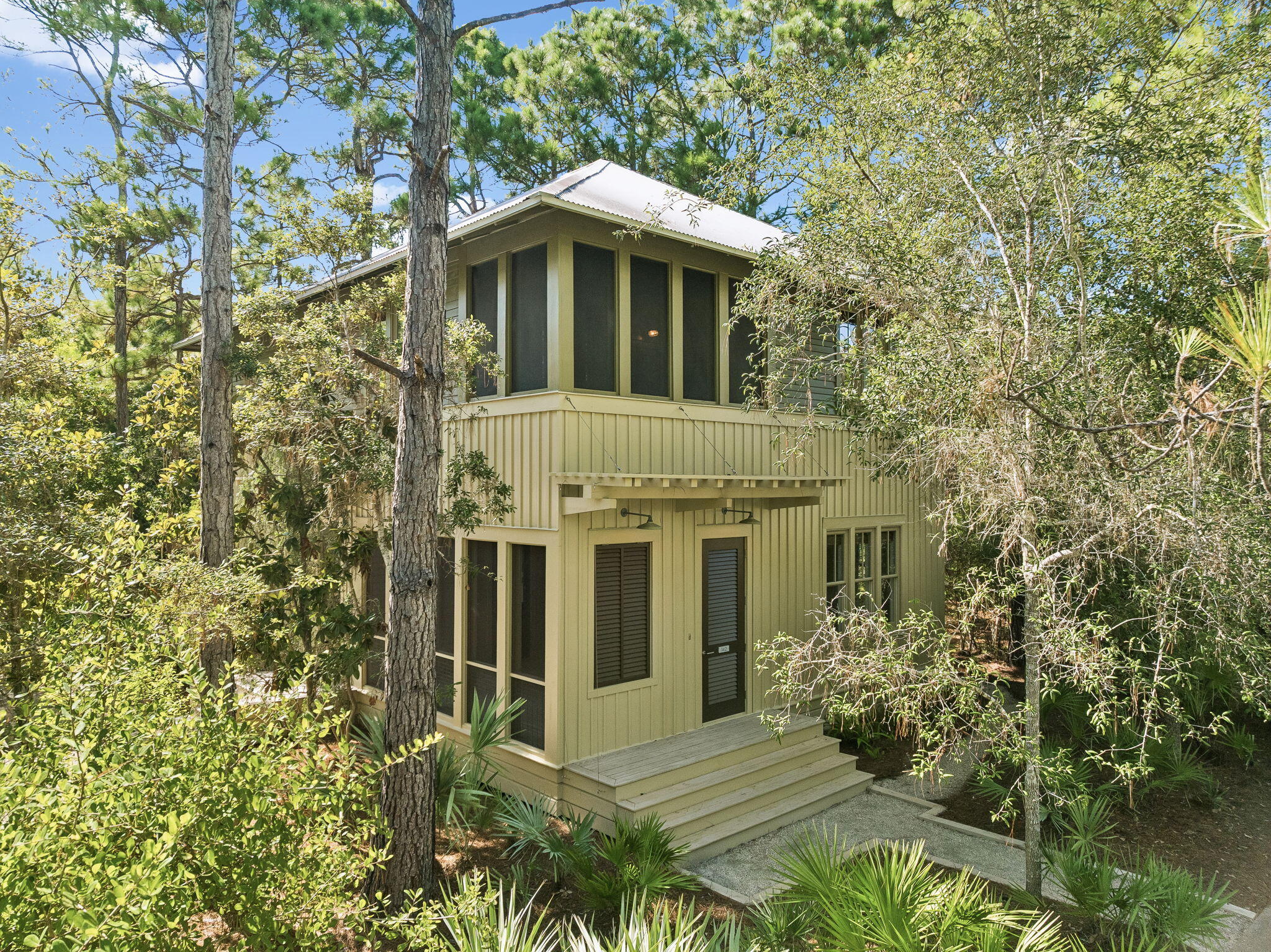 Located in the coastal dune lake community of Lakeplace at Grayton Beach, this distinctive 3-bedroom, 2.5-bath cottage with a detached garage and flexible living space captures the spirit of old Grayton Beach. Tucked away south of Scenic Highway 30A within a private, gated neighborhood, the home is surrounded by mature trees and native landscaping, offering exceptional privacy and a strong connection to nature.

Designed by renowned architect Lourdes Reynafarje and curated as a local interior designer's personal beach cottage, this one-of-a-kind bungalow reflects the character and enduring style of the original homes of Seaside and Grayton Beach. Rich textures, layered interiors, and carefully selected finishes create inviting living spaces filled with personality. Cypress wood sourced from the historic St. Joe Blountstown Mill was used throughout the interior and exterior, while antique oak floors from Olde Savannah Flooring add warmth and authenticity. Celebrated for its classic architecture and authentic Grayton Beach aesthetic, the home was featured in the book 30A Living.

A spacious screened porch seamlessly extends the home's living space, providing an inviting setting for casual gatherings and year-round enjoyment. The floor plan also features a detached garage with a versatile bonus room and half bath, well suited for a home office, gym, or artist's studio. Beautifully maintained and move-in ready, the home is set on a generous lot with ample room to expand, offering a variety of possibilities--from enhancing outdoor living spaces to considering future additions--while delivering outstanding flexibility and long-term potential.

Lakeplace at Grayton Beach is a charming, 20-acre gated community tucked away south of 30A.  Bordering Grayton Beach State Park and Western Lake, this rental-restricted neighborhood offers a rare blend of privacy, natural beauty, and convenience, just minutes from the beach and the beloved shops and restaurants of Grayton Beach.  Residents enjoy thoughtfully maintained amenities, including a community pool and a lakeside dock on Western Lake, perfect for launching paddleboards and kayaks or gathering to watch the sunset. Set in one of 30A's most cherished coastal communities, this home blends thoughtful design and natural beauty with the relaxed, authentic lifestyle that defines Grayton Beach.